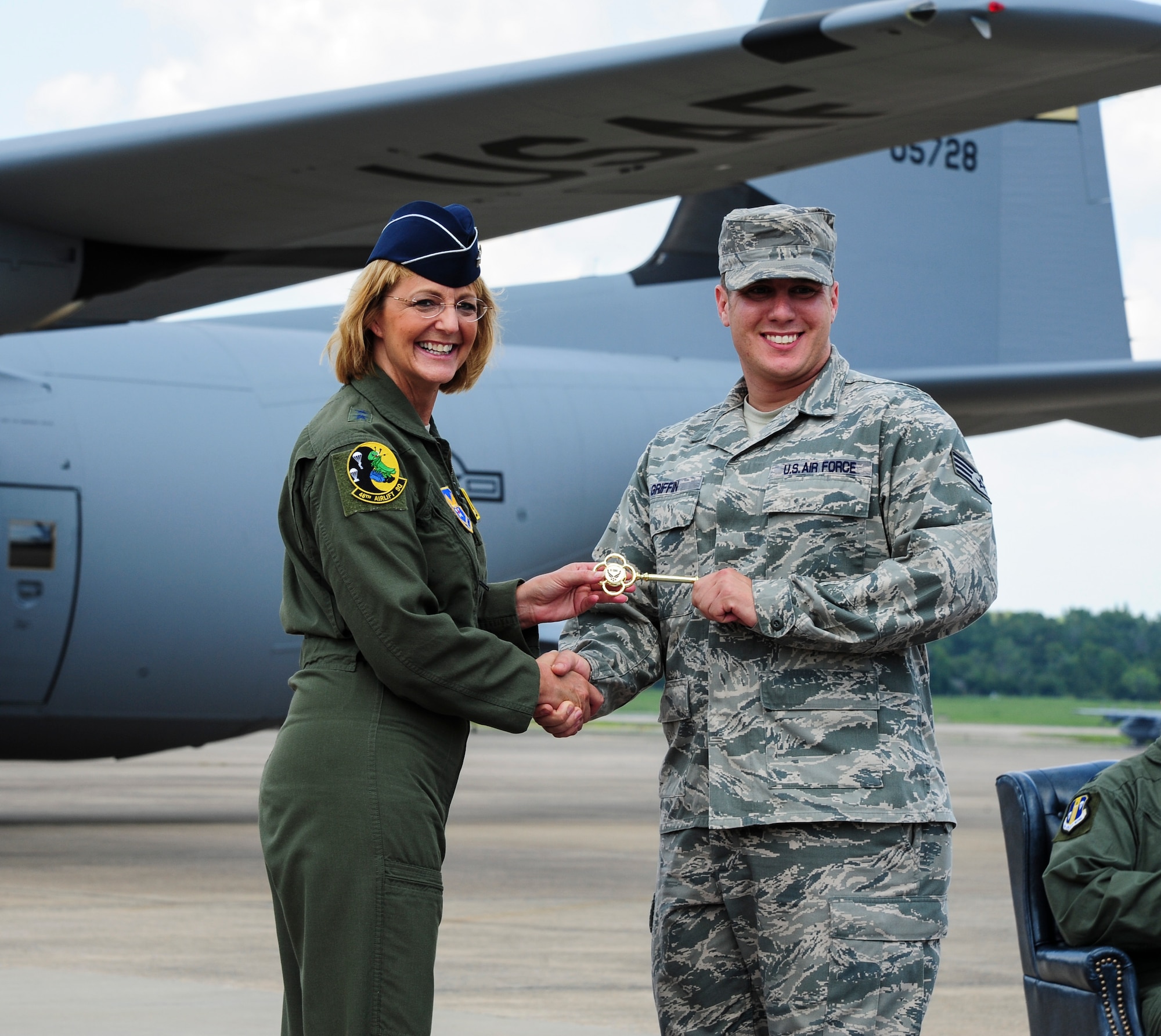 Maj. Gen. Margaret Woodward, director of the Air Force Sexual Assault Prevention and Response Office, presents the “key” to the newest C-130J in the Air Force’s inventory to Staff Sgt. Michael Griffin, 314th Aircraft Maintenance Squadron crew chief Aug. 20, 2013, at Little Rock Air Force Base, Ark. The aircraft was signed by civic partners, Team Little Rock leadership and a 41st Airlift Squadron aircrew. (U.S. Air Force photo by Airman 1st Class Kaylee Clark)