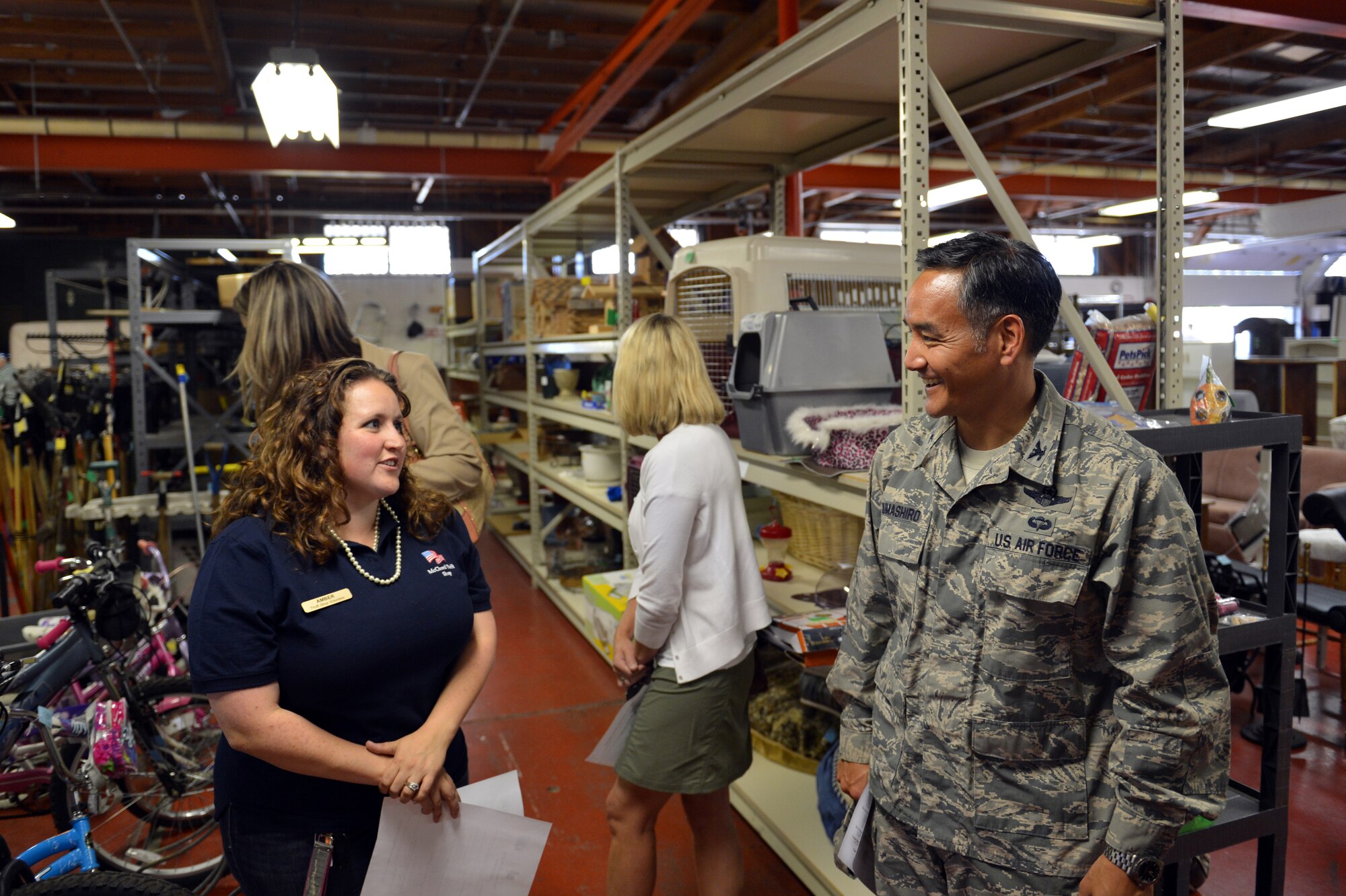 Amber O’Brien, McChord Thrift Shop volunteer, jokes with Col. David Kumashiro, 62nd Airlift Wing commander, during a visit with military spouses to the McChord Thrift Shop, Aug. 20, 2013 at Joint Base Lewis-McChord, Wash. Kumashiro has been the wing commander for more than a month and is currently touring every facility and work center that makes up Team McChord. (U.S. Air Force photo/Staff Sgt. Jason Truskowski)