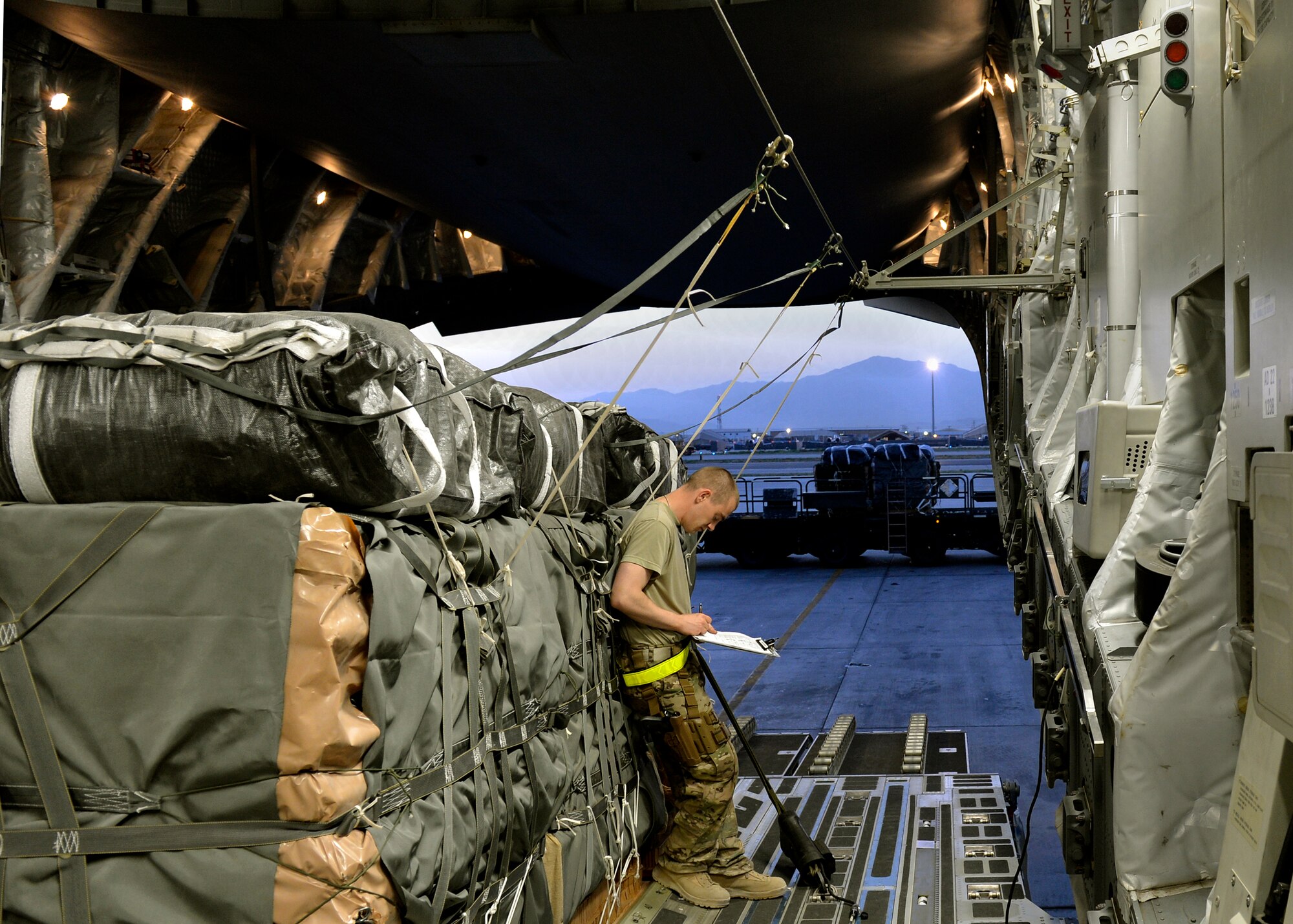 Staff Sgt. Kevin Johnson 455th Expeditionary Operations Support Squadron, NCO in charge of joint airdrop inspector’s office, completes an airdrop bundle inspection form prior to the C-17 loadmasters signing it on Bagram Airfield, Afghanistan, August 21, 2013. Airdrops provide ground members in isolated locations of Afghanistan with food, fuel and supplies daily.  Prior to an airdrop taking place, there are three members who must ensure the cargo is loaded properly in order for an airdrop to successfully occur. The U.S. Army Combined Joint Task Force rigors, who load the cargo onto the aircraft, attach ties and static lines securing it to the aircraft. The JAI inspector whose job is to inspect the riggers work, and the aircraft’s loadmaster who confirms the JAI’s performed an inspection. Johnson is one of two Airmen qualified to perform JAI inspections here. He is deployed from Joint Base Lewis-McChord, Wash., and a native of Wiesbaden, Germany. (U.S. Air Force photo/ Staff Sgt. Stephenie Wade)