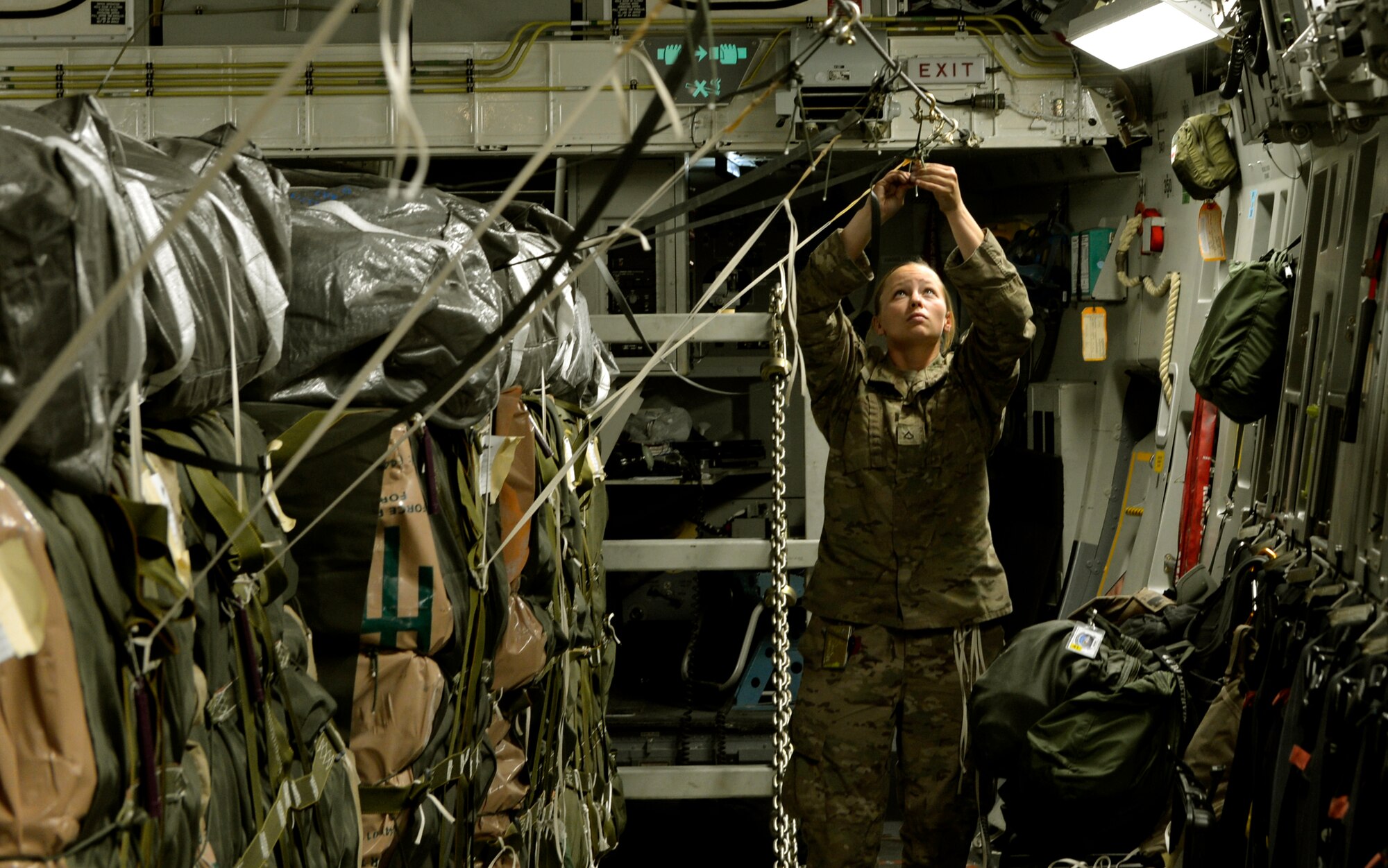 Private First Class Courtney Erwin secures an anchor cable to a C-17 assigned the 774th Expeditionary Airlift Squadron on Bagram Airfield, Afghanistan August 21, 2013.  The cable is attached to an airdrop cargo bundle to be distributed to ground troops in Afghanistan. (U.S. Air Force photo/ Staff Sgt. Stephenie Wade)