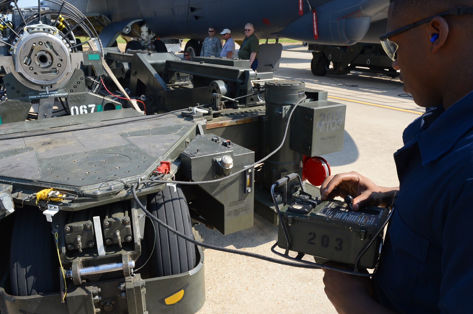 Senior Airman Akeem Bobo, 2nd Maintenance Group weapons standardization crew member, tests a power control unit connected to a strategic rotary launcher trailer on Barksdale Air Force Base, La., Aug. 20, 2013. The PCU is tested to ensure the controls are functioning precisely. Once tested, the trailer is then moved into position so munitions can be loaded. (U.S. Air Force photo/Senior Airman Micaiah Anthony)
