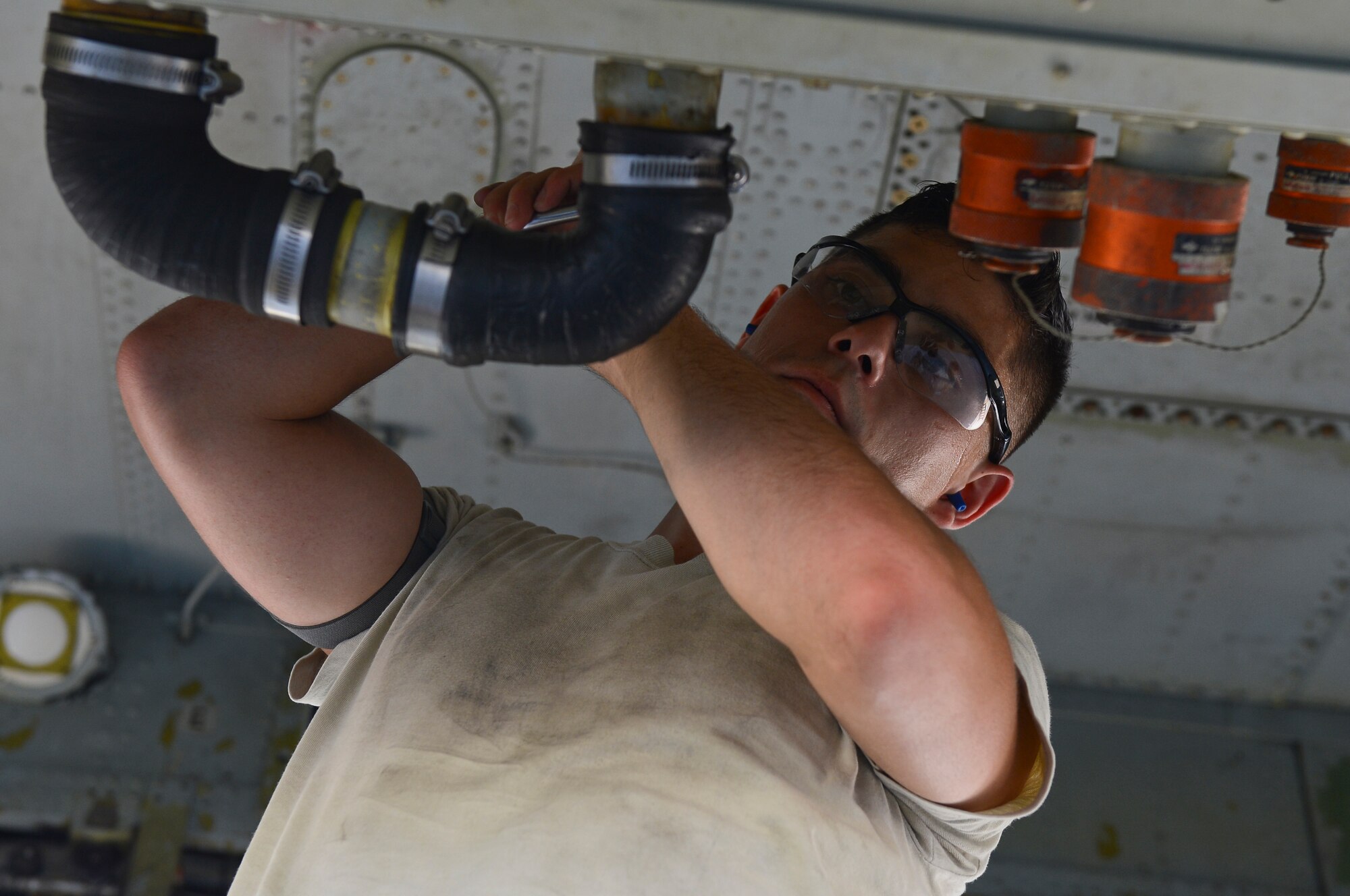 Senior Airman Christopher Rider, 2nd Maintenance Group weapons standardization crew member, detaches a U-tube from a B-52H Stratofortress on Barksdale Air Force Base, La., Aug. 20, 2013. Rider and his crew took part in a technical order verification process allowing for strategic munitions loads to be more efficient by eliminating downtime for crew members waiting for the next step.  (U.S. Air Force photo/Senior Airman Micaiah Anthony)
