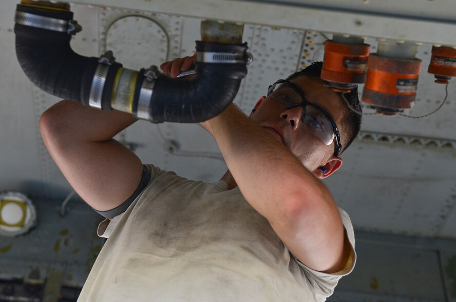 Senior Airman Christopher Rider, 2nd Maintenance Group weapons standardization crew member, detaches a U-tube from a B-52H Stratofortress on Barksdale Air Force Base, La., Aug. 20, 2013. Rider and his crew took part in a technical order verification process allowing for strategic munitions loads to be more efficient by eliminating downtime for crew members waiting for the next step.  (U.S. Air Force photo/Senior Airman Micaiah Anthony)
