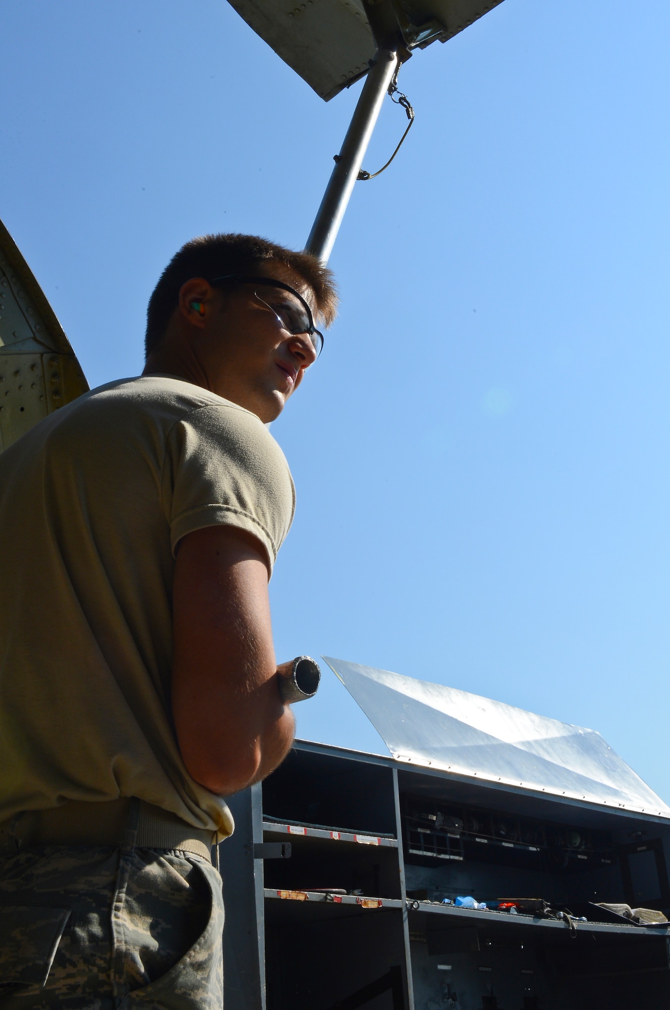 Senior Airman Matthew Fernandez, 2nd Maintenance Group weapons standardization crew member, holds up a bomb bay door on Barksdale Air Force Base, La., Aug. 20, 2013.  The bomb bay doors were opened up to load a strategic rotary launcher as a part of a technical order verification process. The process had Airmen walk through the loading procedures to find a more efficient way to load strategic munitions. (U.S. Air Force photo/Senior Airman Micaiah Anthony)
