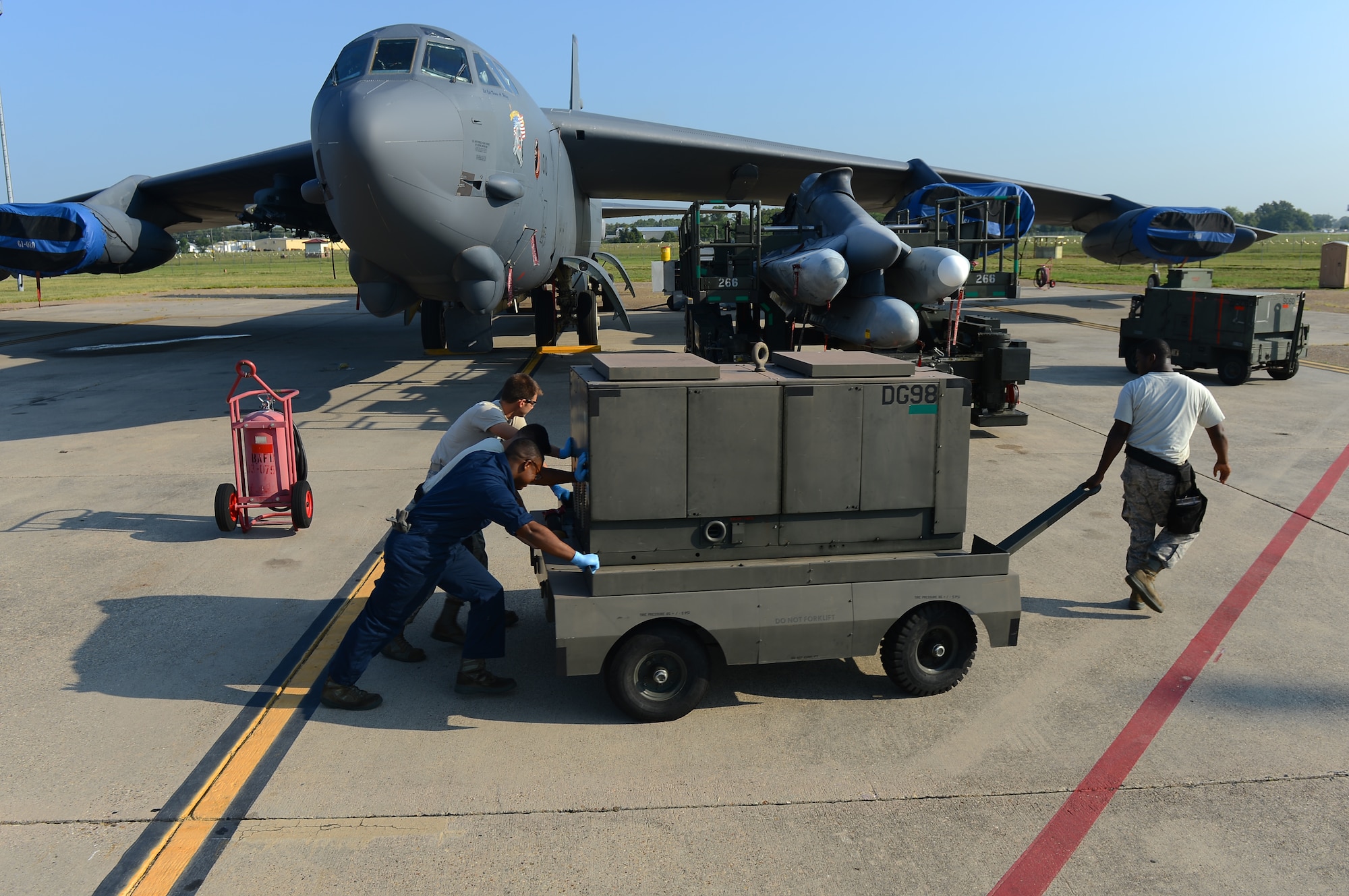 A 2nd Maintenance Group weapons standardization crew positions a ground power cart next to a munitions trailer on Barksdale Air Force Base, La., Aug. 20, 2013. Once the power supply is connected to the trailer, the weapons crew will be able to maneuver the trailer into position. (U.S. Air Force photo/Senior Airman Micaiah Anthony)
