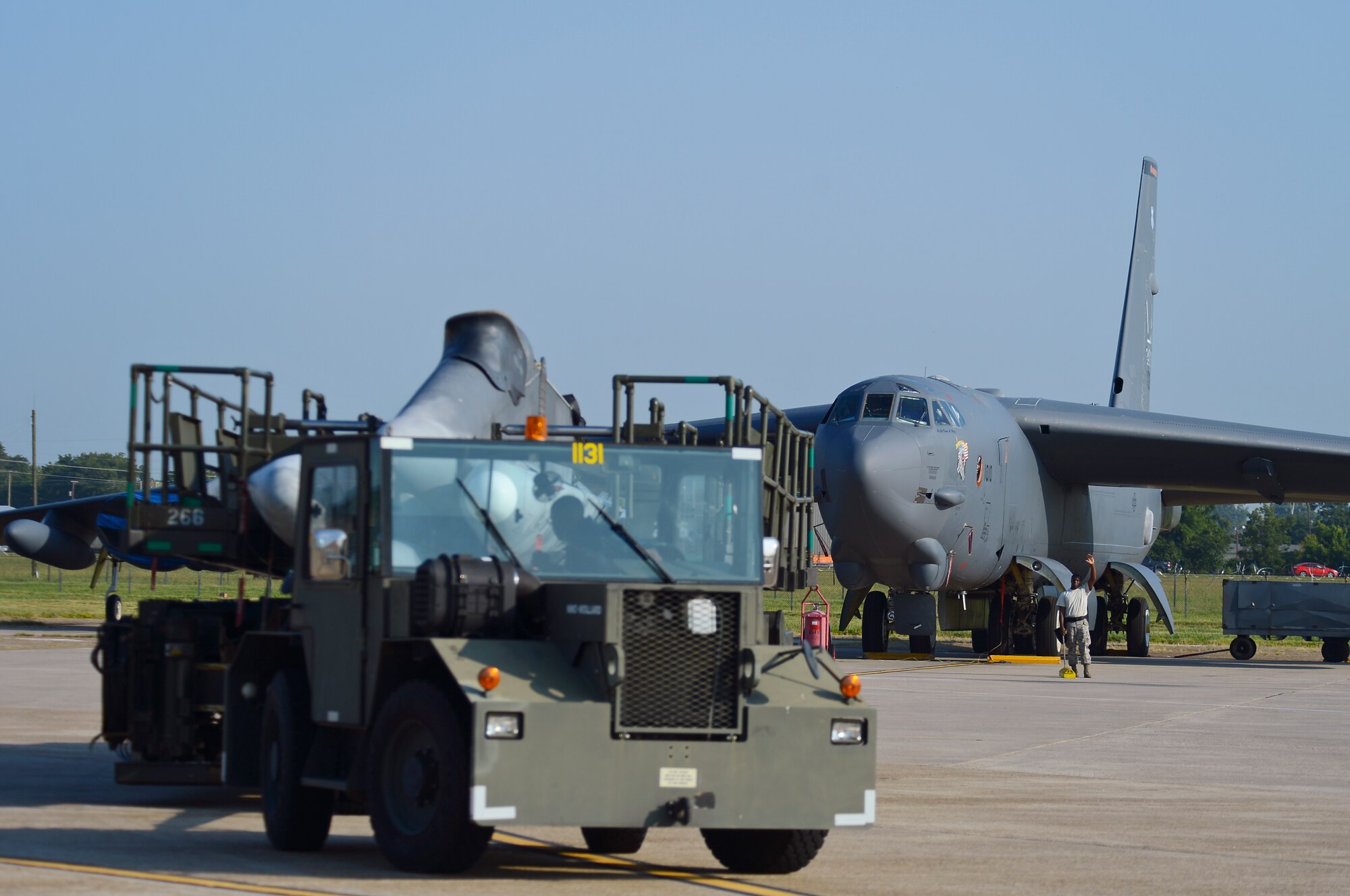 Senior Airman Akeem Bobo, 2nd Maintenance Group weapons standardization crew member, backs up a truck carrying air launch cruise missiles as Staff Sgt. Raymond Edgerson, 2nd MXG weapons standardization crew team chief, guides him on Barksdale Air Force Base, La., Aug. 20, 2013. The lead weapons standardization crew walked through ALCM loading procedures so the technical orders could be modified to improve efficiency. (U.S. Air Force photo/Senior Airman Micaiah Anthony) 
