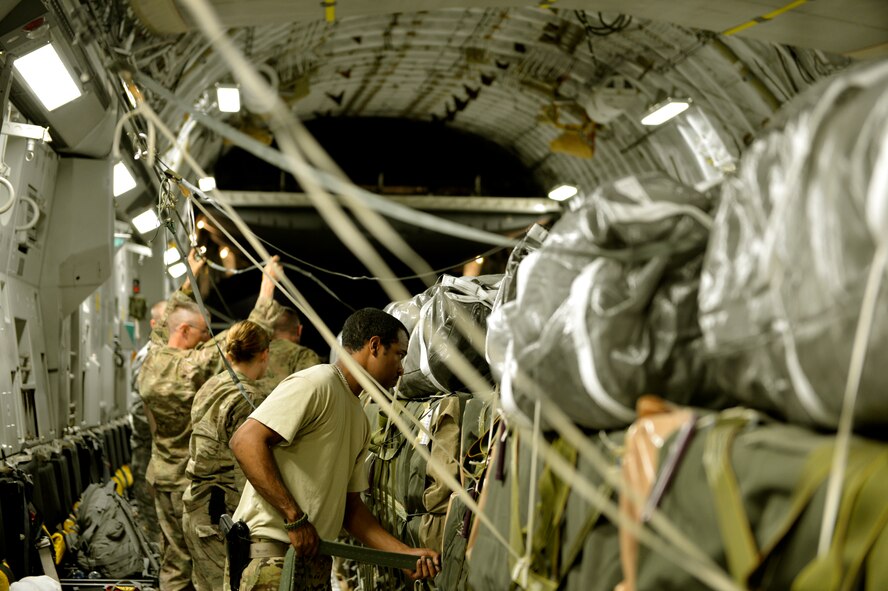 Senior Airman Shaun Larue, 455th Expeditionary Operations Support Squadron Joint Airdrop Inspection journeyman, inspects cargo straps and riggers holding down cargo in a C-17 on Bagram Airfield, Afghanistan, August 21, 2013.  He is deployed from Pope Air Force Base, N.C  (U.S. Air Force photo/ Staff Sgt. Stephenie Wade)
