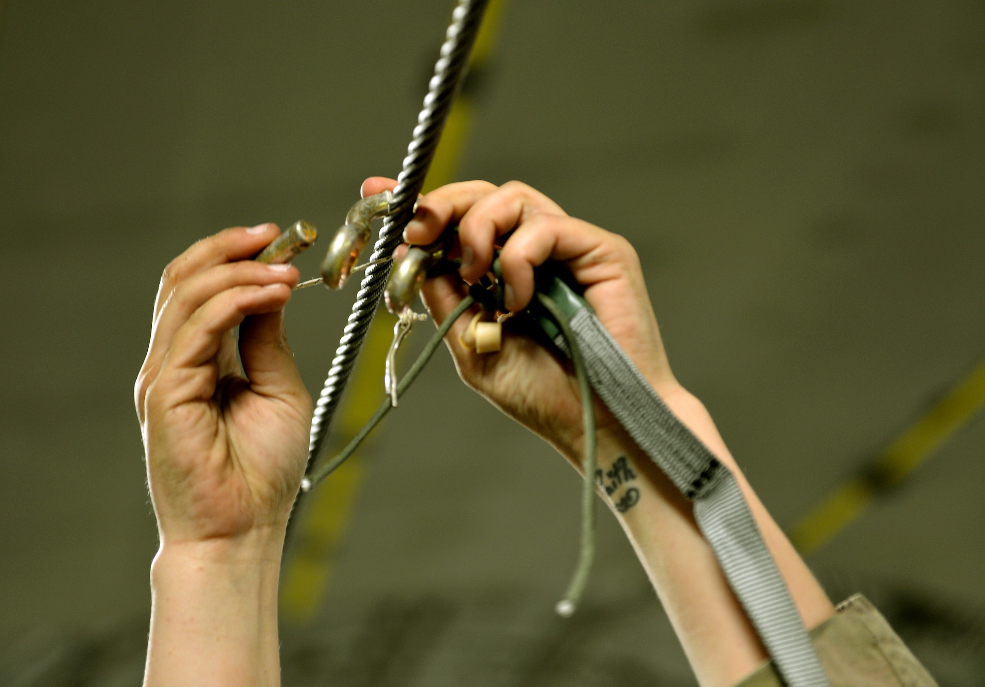 Private First Class Courtney Erwin secures an anchor cable to a C-17 assigned the 774th Expeditionary Airlift Squadron on Bagram Airfield, Afghanistan, August 21, 2013.  The cable is attached to an airdrop cargo bundle to be distributed to ground troops in Afghanistan. (U.S. Air Force photo/ Staff Sgt. Stephenie Wade)