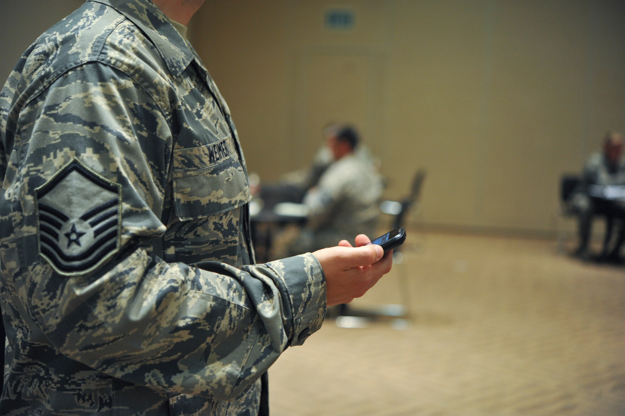 Master Sgt. Shaun Weimer, 460th Space Communications Squadron, keeps  time at Buckley’s first ever speed mentoring Aug. 15, 2013, at the Leadership Development Center on Buckley Air Force Base, Colo. Each Air Force master sergeant was allotted a five to seven minute one-on-one session where they discussed personal and professional development, special duties, promotion, and leadership. (U.S. Air Force photo by Airman 1st Class Riley Johnson/Released)