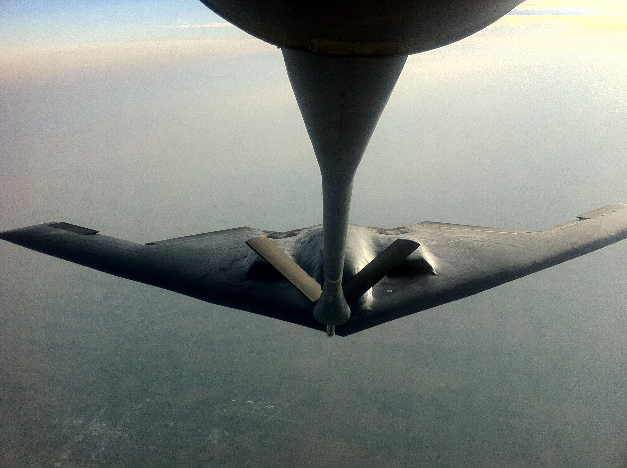 A KC-135 Stratotanker from the 931st Air Refueling Group out of McConnell Air Force Base, Kan. extends its boom to fuel a B-2 bomber from the 509th Bomber Wing out of Whiteman AFB, Mo. (Air Force photo by Master Sgt. James Yokom)