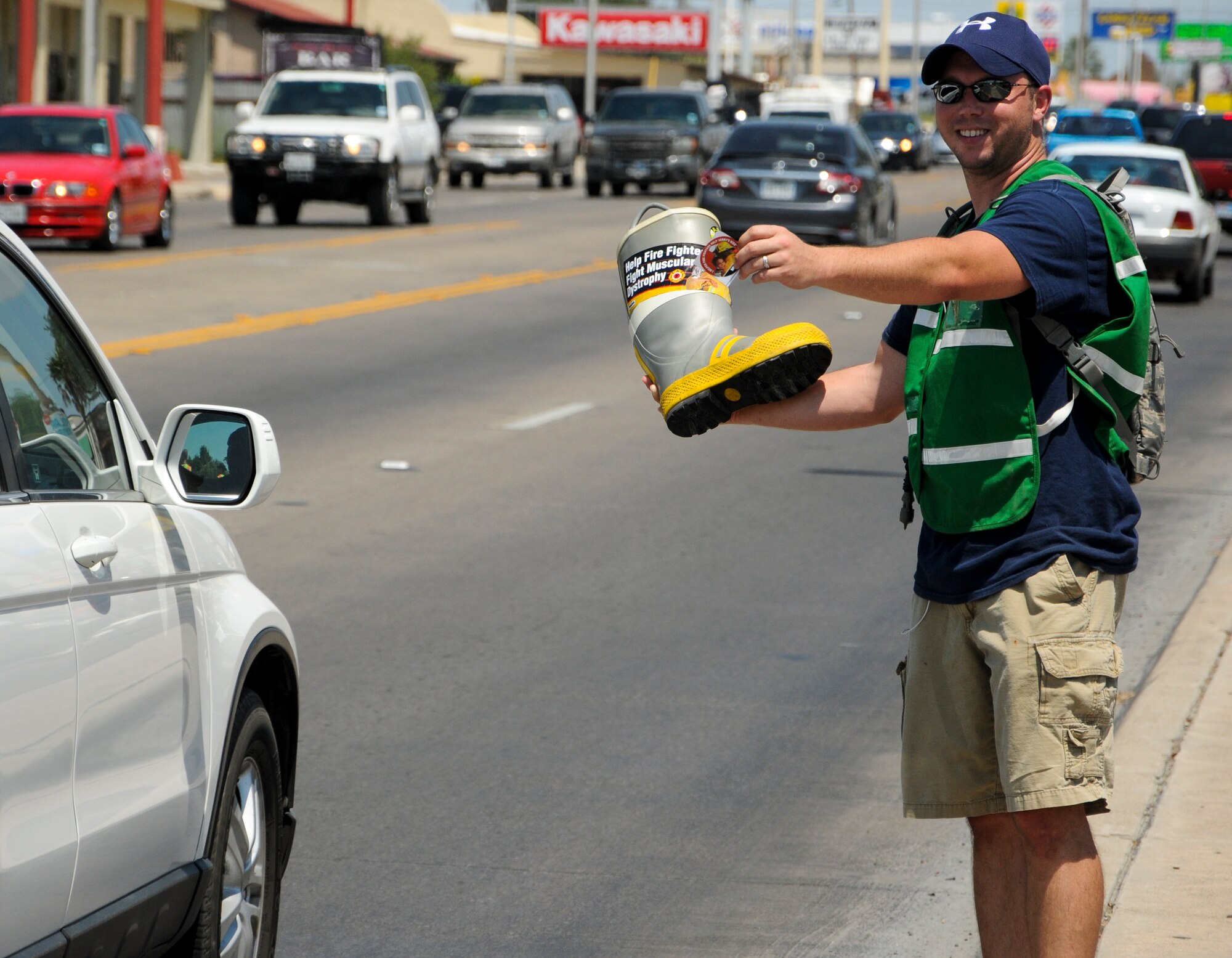 Staff Sgt. William Del Castillo, 47th Civil Engineer Squadron fire fighter, asks for donations in Del Rio, Texas, Aug. 17, 2013. He and other Laughlin firefighters, along with their Del Rio counterparts, asked for donations from the local community for “Fill the Boot”, a campaign that raises money to fight neuromuscular disease. (U.S. Air Force photo/Senior Airman John D. Partlow)