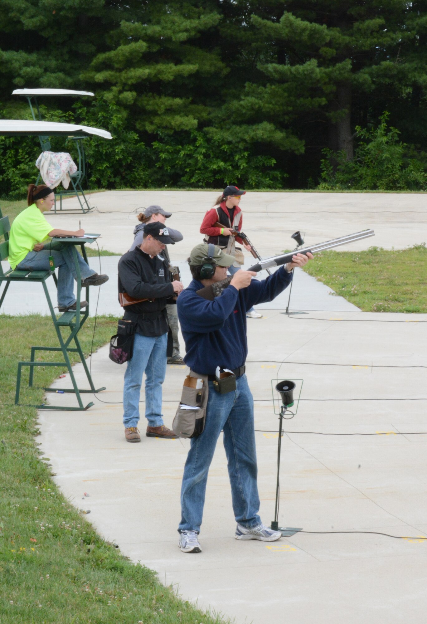 Participants take turns aiming at their clay targets during the shotgun portion of the 2nd Annual Explosive Ordnance Disposal Warrior 3-Gun Shoot at the Deerfield Rod and Gun Club in Deerfield, Wis., July 27, 2013. Glass trophies were handed out to the best shotgun, rifle and pistal shooters during the event that raised approximately $10.000. That money was donated to the EOD Warrior Foundation, an organization that supports EOD warriors and their families, and maintains the EOD Memorial. (Air National Guard photo by Senior Airman Andrea F. Liechti)