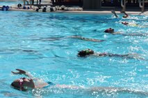 Swimming Class participants practice the back stroke in the outdoor pool at Minot Air Force Base, N.D., Aug. 16, 2013. Swimming lessons have concluded for the summer, but will be picking up again in the winter at the indoor pool located in the McAdoo fitness center also located on base. (U.S. Air Force photo/Airman 1st Class Stephanie Sauberan)