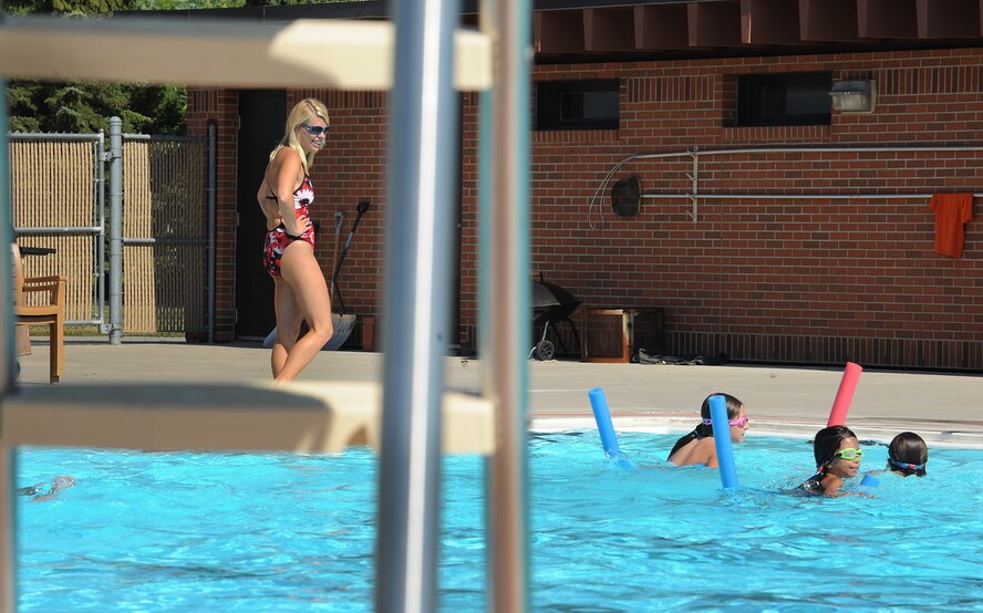 Megan Albers, Outdoor Recreation life guard, watches over swimming class participants during lessons at Minot Air Force Base, N.D., outdoor pool, Aug. 16, 2013 Alberts hails from Center N.D. and has been a life guard for more than 10 years. (U.S. Air Force photo/Airman 1st Class Stephanie Sauberan)
