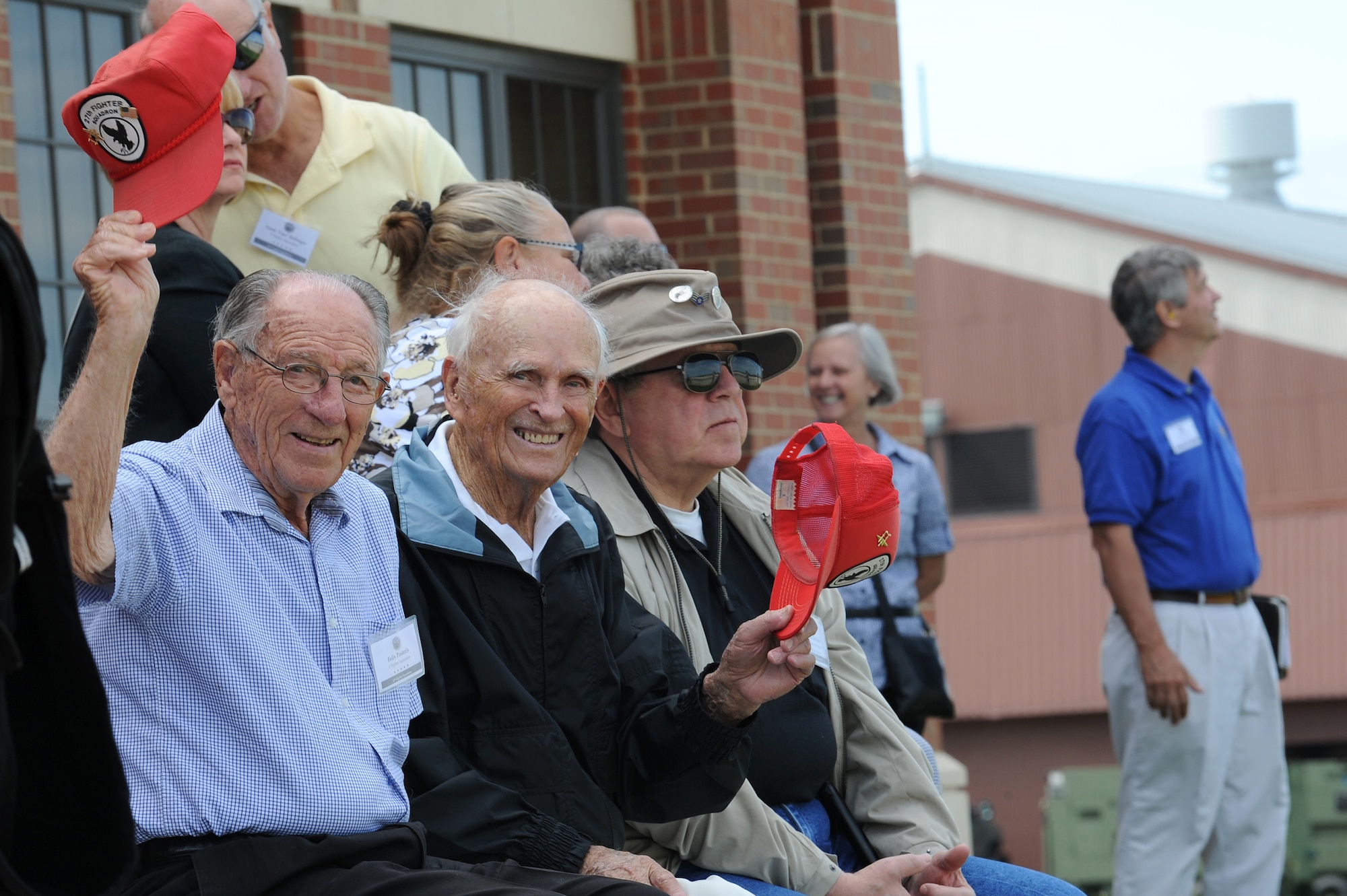 Members of the 1st Fighter Wing Association watch the landing pattern activities of the T-38 Talon and F-22 Raptors during the 1st FWA reunion at Langley Air Force Base, Va., Aug. 16, 2013. Four prior World War II pilots were in attendance at this year’s reunion. (U.S. Air Force photo by Airman 1st Class Kimberly Nagle/Released)