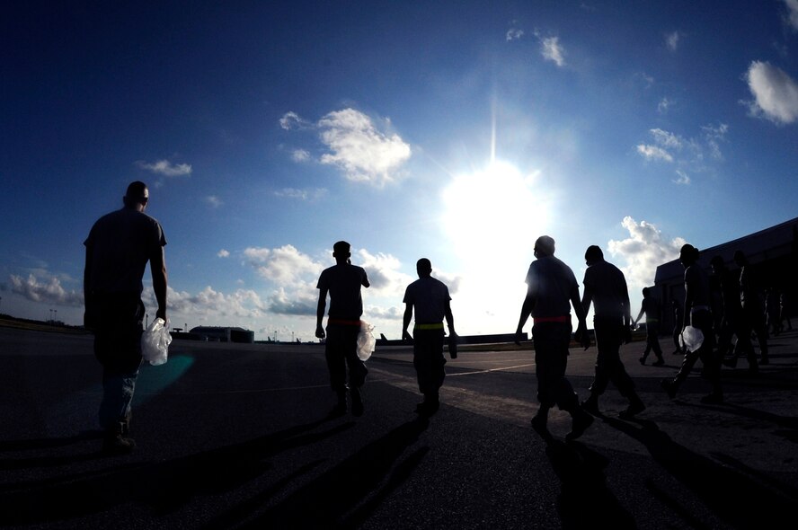 U.S. Air Force Airmen from the 909th Aircraft Maintenance Unit perform a foreign object debris walk on the Kadena Air Base, Japan, flightline Aug. 12, 2013. Aircraft from U.S. and coalition forces alike rely heavily on the 909th Air Refueling Squadron for in-flight refuels in the Pacific, making the 909th AMU a backbone for peace and stability in the region. (U.S. Air Force photo by Senior Airman Maeson L. Elleman/Released)