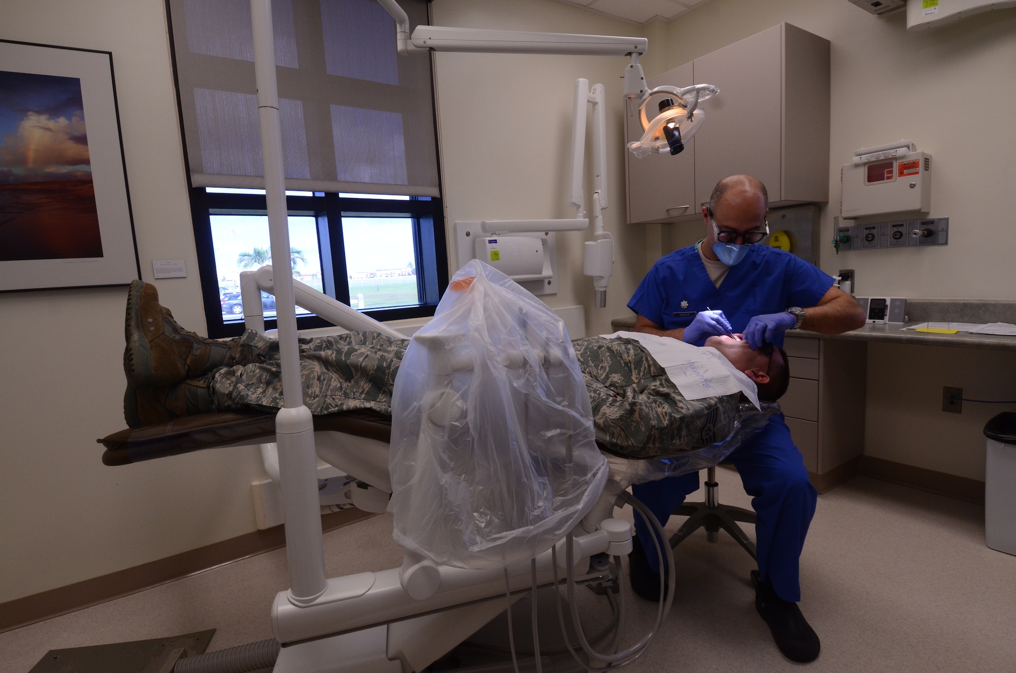 Lt. Col. (Dr.) Michael Suhler, 36th Medical Operations Squadron Dental Flight commander, checks a patient’s overall dental health during an examination Aug. 15, 2013, on Andersen Air Force Base, Guam. The 36th Medical Group Dental Clinic sees more than 30 patients daily. (U.S. Air Force photo by Airman 1st Class Emily A. Bradley/Released)