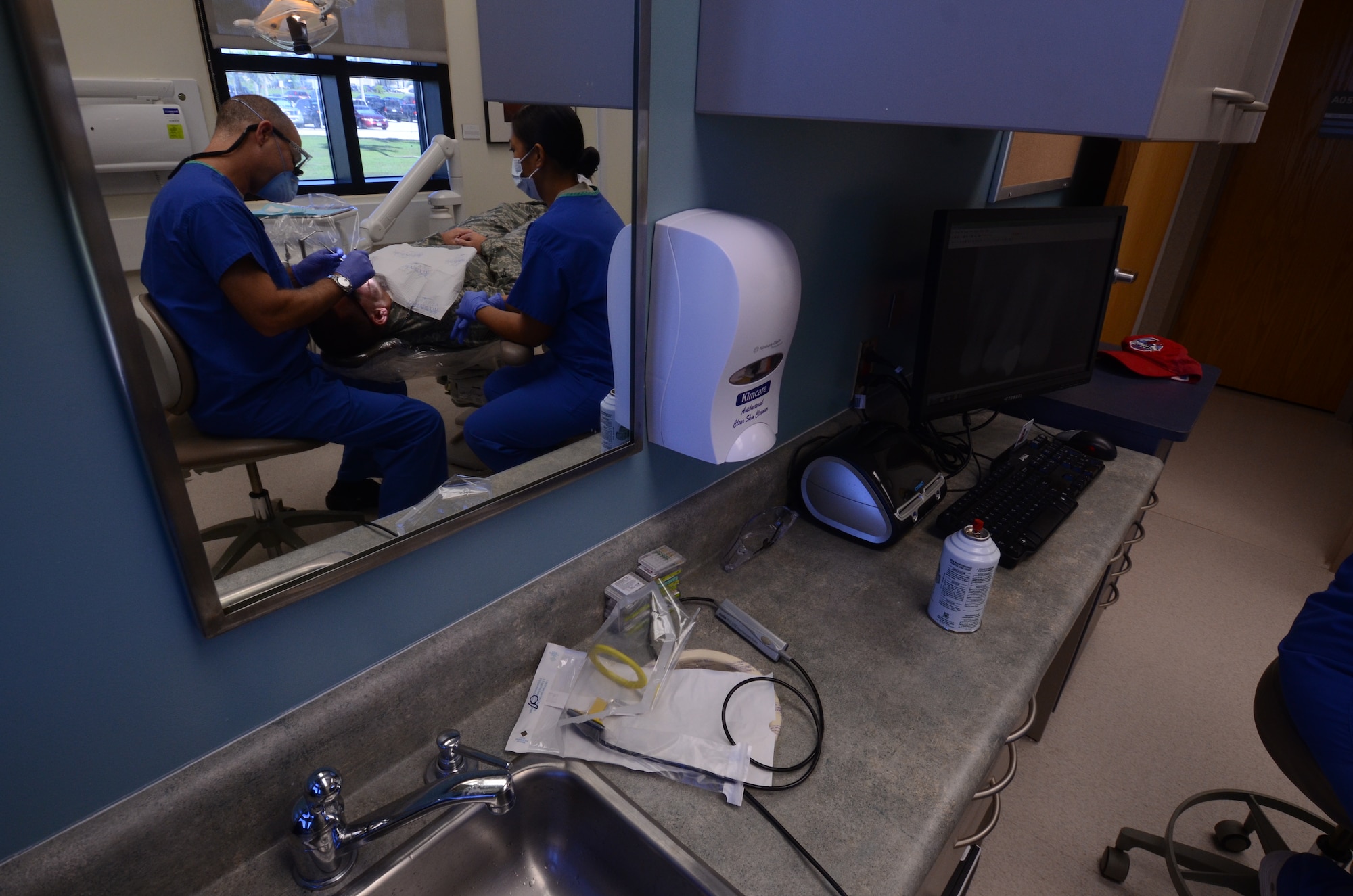 Lt. Col. (Dr.) Michael Suhler, 36th Medical Operations Support Dental Flight commander, conducts a cold sensitivity test on a patient’s teeth to determine if there are any dead nerves, Aug. 15, 2013, on Andersen Air Force Base, Guam. The 36th Medical Group Dental Clinic sees more than 30 patients daily.  (U.S. Air Force photo by Airman 1st Class Emily A. Bradley/Released)