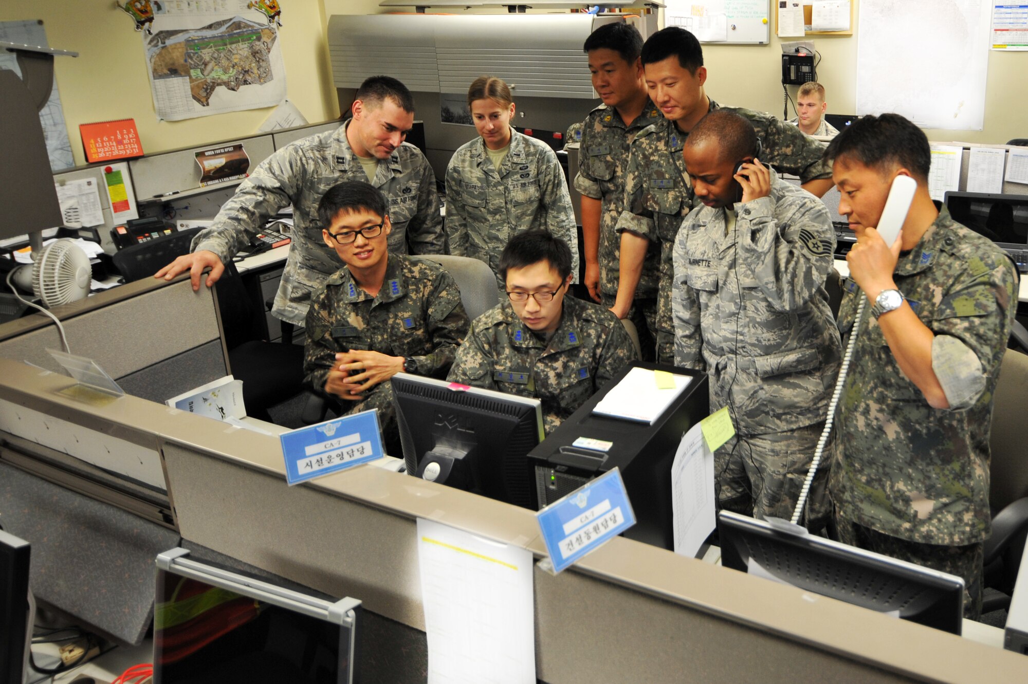 Republic of Korea Air Force and U.S. Air Force Airmen from the Air Component Command Installations and Mission Support directorate, monitor exercise civil engineer operations during Ulchi Freedom Guardian 2013 at Osan Air Base, ROK, Aug. 20, 2013. Among other tasks, the civil engineers ensure airfields on the peninsula are kept open to allow for the launch of combat sorties during the exercise. The annual exercise, conducted by the ROK and U.S. Combined Forces Command, runs through Aug. 30. (U.S. Air Force photo/Staff Sgt. Emerson Nuñez)