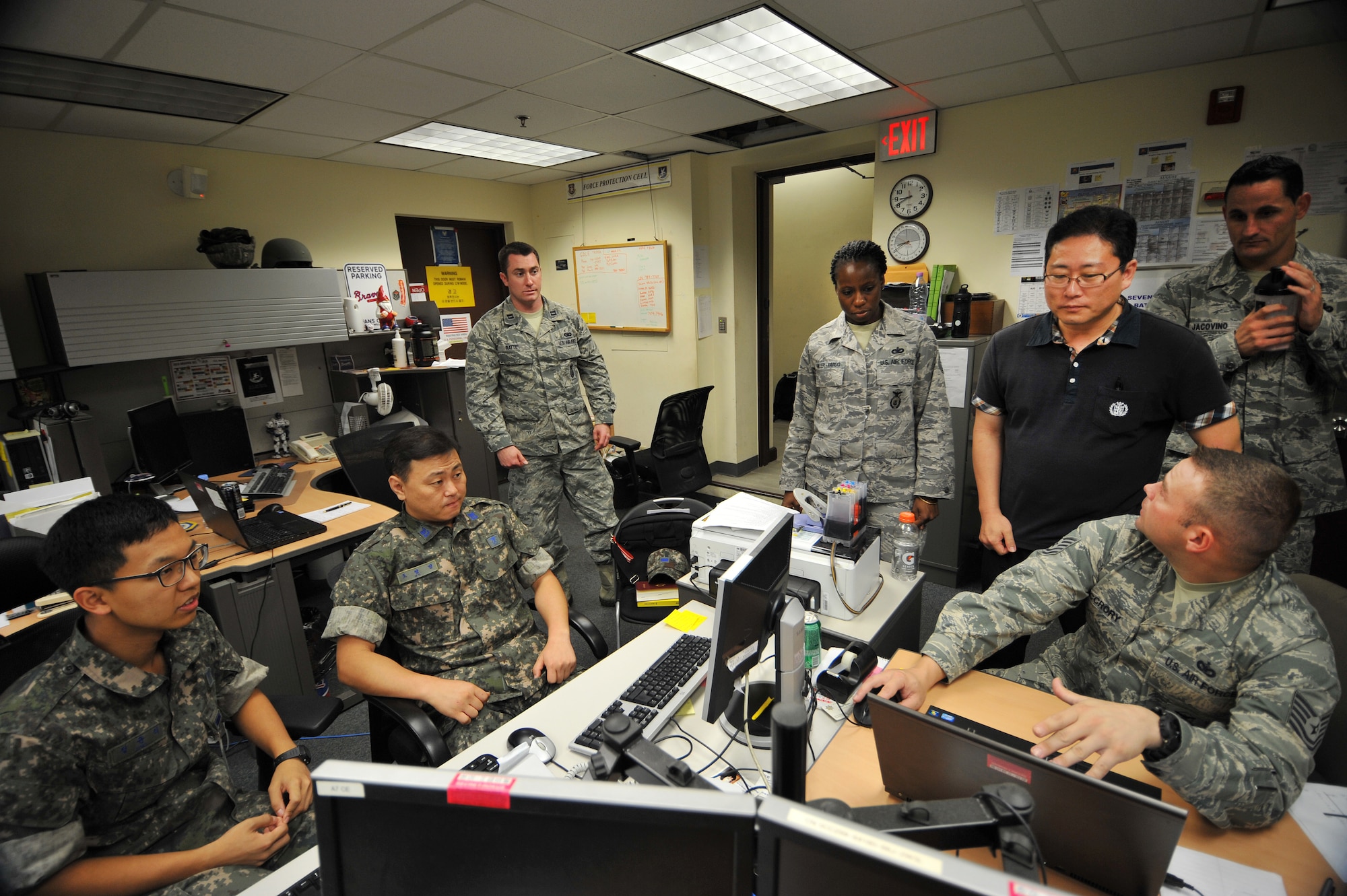 Republic of Korea Air Force and U.S. Air Force Airmen from the Air Component Command force protection cell discuss an exercise scenario during Ulchi Freedom Guardian 2013 at Osan Air Base, ROK, Aug. 20, 2013. Force protection cell Airmen monitor and coordinate air base defense activities and allocate ground defense forces and equipment for all ACC bases throughout the peninsula. UFG is a critical alliance exercise to sustain the readiness of the ROK, U.S. forces and sending state forces. (U.S. Air Force photo/Staff Sgt. Emerson Nuñez)