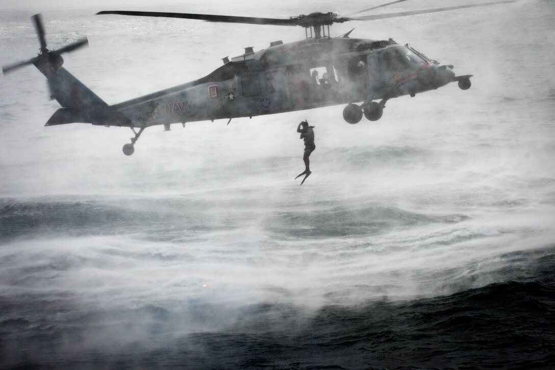 A U.S. Navy search and rescue swimmer jumps from an MH-60S Seahawk helicopter during training in the U.S. 5th Fleet area of responsibility, Aug. 17, 2013. The swimmer is assigned to Helicopter Sea Combat Squadron 6, which is deployed with the Nimitz Carrier Strike Group to conduct security operations and security cooperation efforts to support Operation Enduring Freedom.