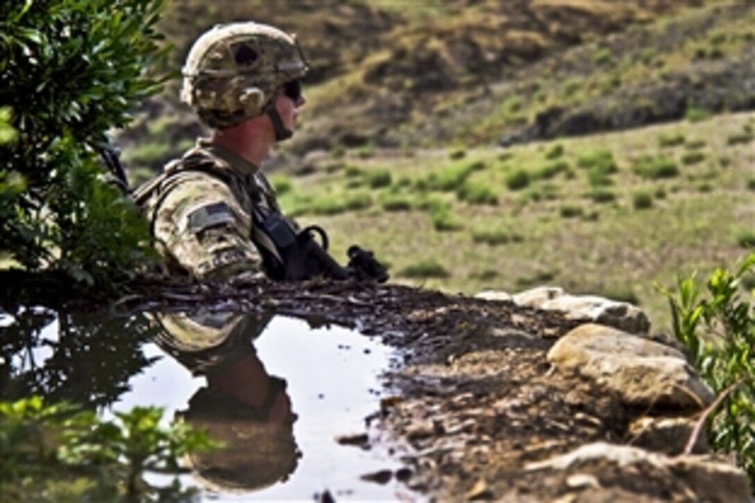 U.S. Army Sgt. Justin A. Clymer scans the surrounding area during a patrol to clear routes in Khowst province, Afghanistan, Aug. 14, 2013. Clymer, a combat engineer, is assigned to the 101st Airborne Division's Company A, 4th Brigade Special Troops Battalion, 4th Brigade Combat Team.