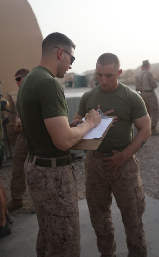 Lance Cpl. Brendan Hennessy, 19, a rifleman with Company E, 2nd Battalion, 8th Marine Regiment, Regimental Combat Team 7, signs up for the weight lifting portion of the strong man competition. "I used to do strongman competitions back in high school," said the Lynbrook, N.Y., native. "Once I really got into the competition, it was like being back in high school again."