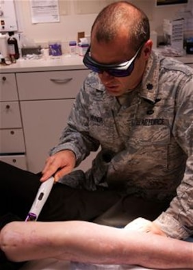 Lt. Col. (Dr.) Chad Hivnor uses a pulsed dye laser to help decrease redness on a wounded warrior’s scarred leg in the Dermatology Clinic at Wilford Hall Ambulatory Surgical Center, Joint Base San Antonio-Lackland, Texas Aug 7, 2013. Hivnor will receive the 2013 Paul W. Myers Award for his work using lasers to improve the skin texture and flexibility on wounded warriors.