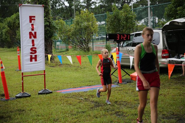 A 10-year-old triathlete runs during Cherry Point's sprint triathlon Saturday.