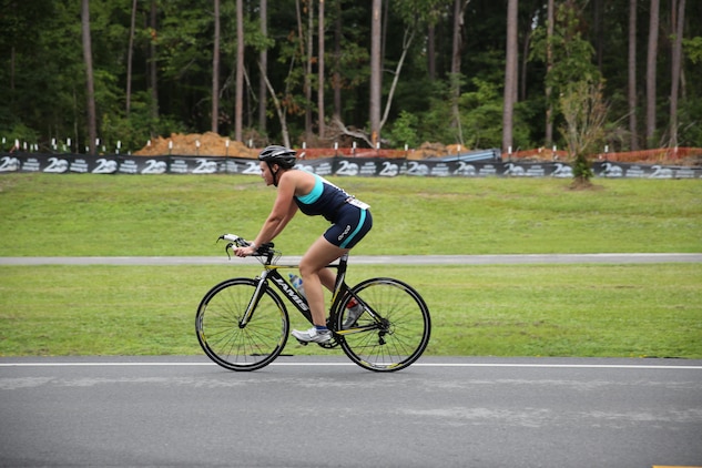 Sandra M. Fairfield, a contestant in Cherry Point's sprint triathlon, bikes her way through a 10-mile bike ride Saturday. Contestants ages 13 and up competed in a 400-meter swim, 10-mile bike miles and 5k run.