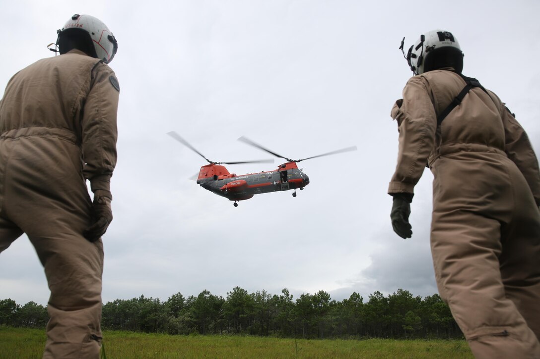 Lance Cpl. Brandon S. Wilson and Petty Officer Second Class Adam J. Woolley watch as the HH-46D Sea Knight dubbed "Pedro" lands on Outlying Landing Field Atlantic Aug. 15 during hoist training.