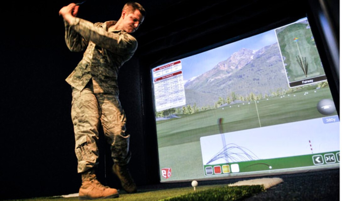 Senior Airman Dane Adams, 354th Communications Squadron cyber transport technician, practices his golf swing during Eielson City Center’s opening March 29, 2013, Eielson Air Force Base, Alaska. The ECC gives Airmen and their families the opportunity for various activities in a central location on base.