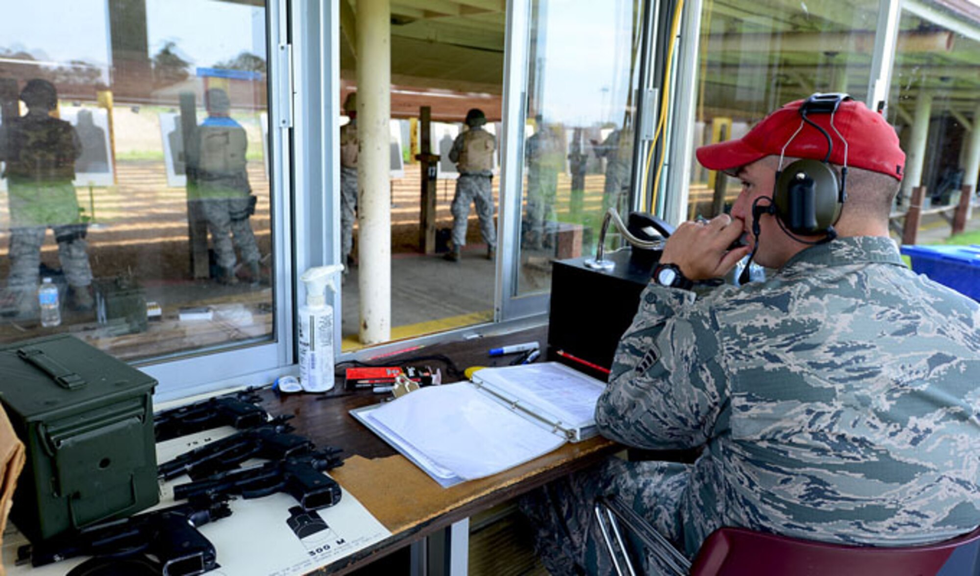 Staff Sgt. William Delphia explains firing procedures on the loud speaker Aug. 13, 2013, at Langley Air Force Base, Va. Combat arms training and maintenance instructors teach weapons qualifications for various reasons such as deployment and permanent change of station. Delphia is a CATM instructor with the 633rd Security Forces Squadron.