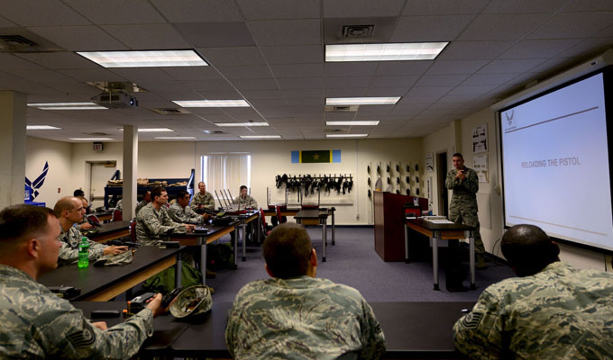 Staff Sgt. William Delphia demonstrates reloading procedures for the M-9 berretta Aug. 13, 2013 at Langley Air Force Base, Va. Delphia usually teaches approximately 15 to 20 students daily. Delphia is a  combat arms training and maintenance instructor with the 633rd Security Forces Squadron.