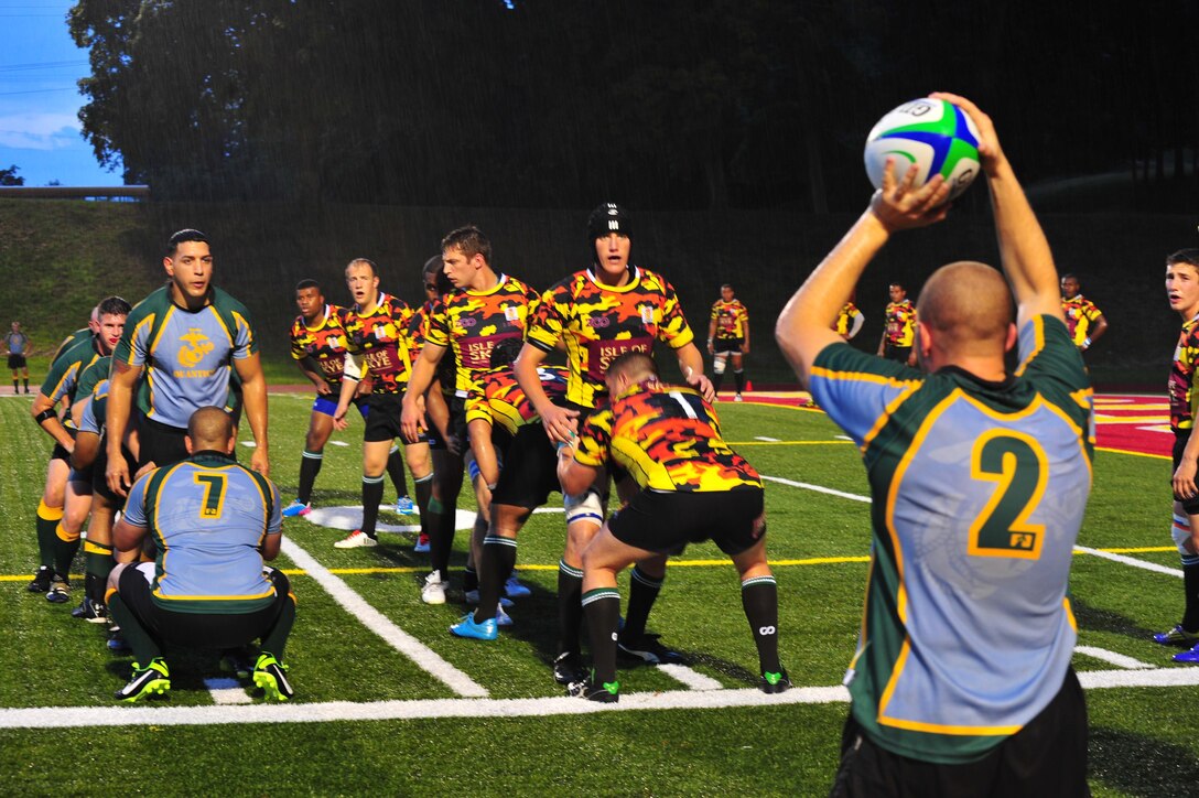A member of the Quantico Hooligans Rugby Football Club throws a ball to begin a play at Butler Stadium aboard Marine Corps Base Quantico on Aug. 22, 2013. The pre-season game, against the 1st Battalion Royal Regiment of Scotland Team, was the first the Hooligans have played this year.