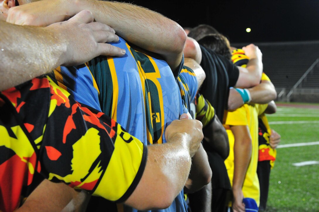 Members of the 1st Battalion Royal Regiment of Scotland Rugby Team and the Quantico Hooligans Rugby Football Club celebrate a good match at Butler Stadium after the first pre-season game of the season aboard Marine Corps Base Quantico on Aug. 22, 2013. The Scottish Team played their first of four games in the Untied States on the base before continuing on to Annapolis, N.Y. and Boston.