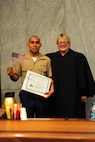 Lance Cpl. Edgar Raul Torres-Roman poses for a photo with the Honorable Cynthia Norton at his naturalization ceremony at the Kansas City Courthouse, Aug. 22. Torres-Roman represented Mexico, one of 32 states in which applicants from the ceremony were citizens. 