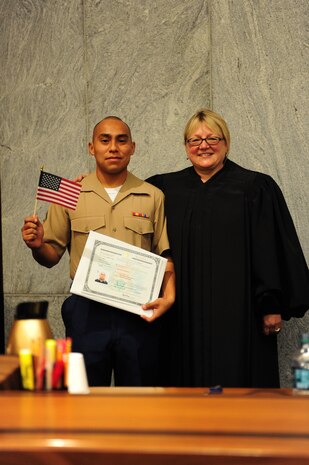 Lance Cpl. Edgar Raul Torres-Roman poses for a photo with the Honorable Cynthia Norton at his naturalization ceremony at the Kansas City Courthouse, Aug. 22. Torres-Roman represented Mexico, one of 32 states in which applicants from the ceremony were citizens. 