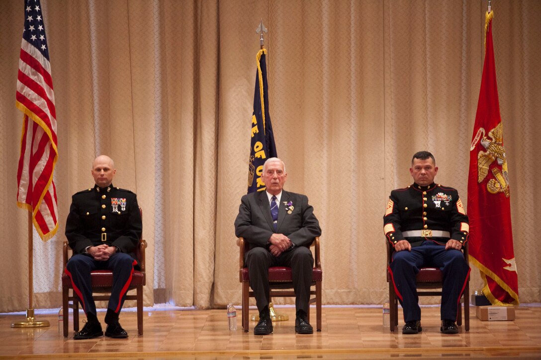 Ernest C. Brace sits between Lt.Col. Kevin A. Williams, the inspector/instructor of 6th Engineer Support Battalion, and Sgt. Maj. Eric D. Sheline, the 6th ESB I&I sergeant major, during his award ceremony at Kingsley Air Force Base here, Aug 16, 2013. Since Brace was a Marine in the Korean War era, 6th ESB Marines made their way to Klamath Falls, Ore., Brace’s hometown, to award him. 