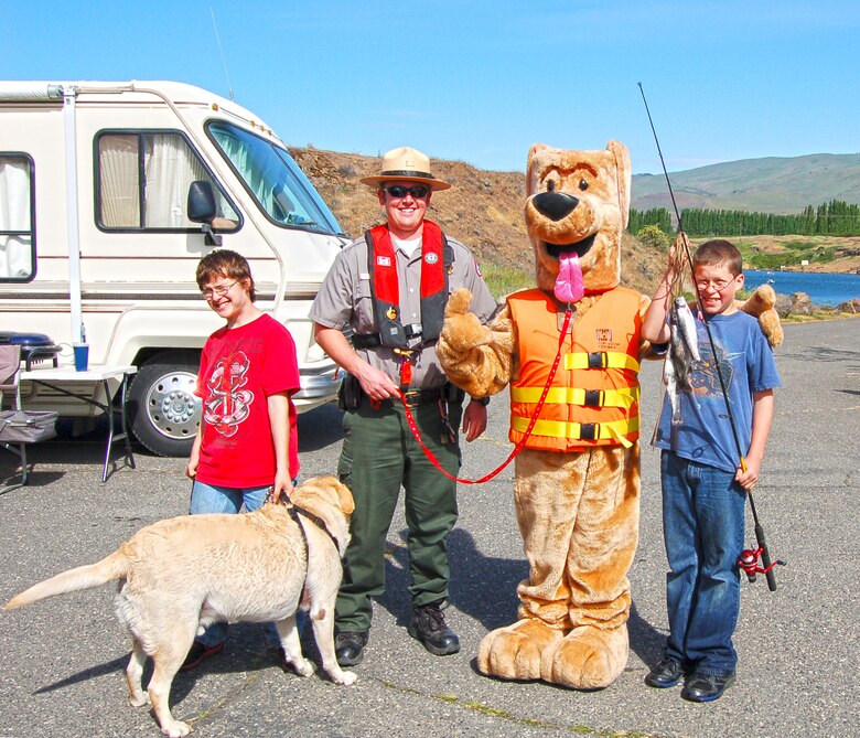 If you were visiting The Dalles in late April of 2013, you might have seen Bobber the Water Safety Dog while on his road trip with park ranger Amber Tilton, Kelly Thomas and David Ladouceur from The Dalles Lock and Dam.  

The day-long tour included a stop at Columbia Hills State Park to promote water safety in the Gorge and perform free boater safety checks in partnership with rangers from Washington State Parks and Washington Department of Fish and Wildlife.  They also visited Spearfish Lake and met with families who were there for the lakes’ opening fishing celebration … those casting for trout received bobbers and kids were given coloring books to help remind them to stay afloat by wearing a properly-fitted life jacket.  

Bobber the Water Safety Dog and his entourage ended their water safety adventures at the annual Cherry Fest where Bobber fitted life jackets and demonstrated how to be a “Smart Thinker – Not a Sinker” by wearing a life jacket.