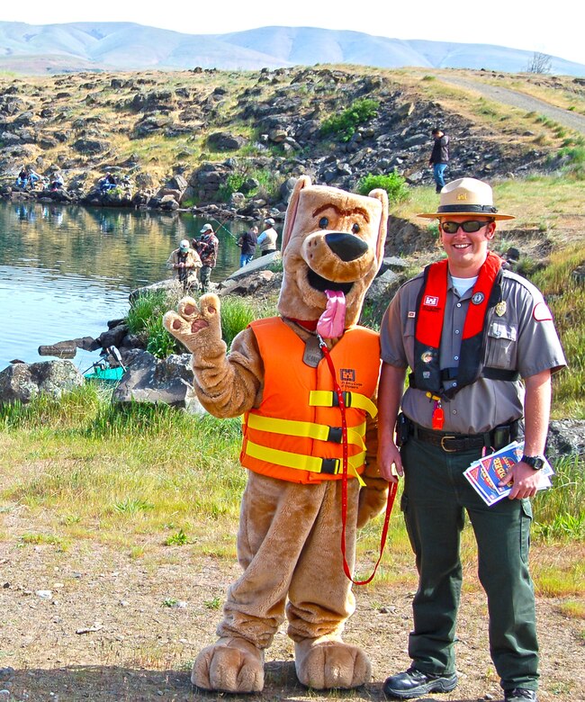 If you were visiting The Dalles in late April of 2013, you might have seen Bobber the Water Safety Dog while on his road trip with park ranger Amber Tilton, Kelly Thomas and David Ladouceur from The Dalles Lock and Dam.  

The day-long tour included a stop at Columbia Hills State Park to promote water safety in the Gorge and perform free boater safety checks in partnership with rangers from Washington State Parks and Washington Department of Fish and Wildlife.  They also visited Spearfish Lake and met with families who were there for the lakes’ opening fishing celebration … those casting for trout received bobbers and kids were given coloring books to help remind them to stay afloat by wearing a properly-fitted life jacket.  

Bobber the Water Safety Dog and his entourage ended their water safety adventures at the annual Cherry Fest where Bobber fitted life jackets and demonstrated how to be a “Smart Thinker – Not a Sinker” by wearing a life jacket.