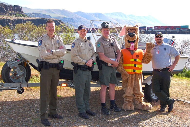 If you were visiting The Dalles in late April of 2013, you might have seen Bobber the Water Safety Dog while on his road trip with park ranger Amber Tilton, Kelly Thomas and David Ladouceur from The Dalles Lock and Dam.  

The day-long tour included a stop at Columbia Hills State Park to promote water safety in the Gorge and perform free boater safety checks in partnership with rangers from Washington State Parks and Washington Department of Fish and Wildlife.  They also visited Spearfish Lake and met with families who were there for the lakes’ opening fishing celebration … those casting for trout received bobbers and kids were given coloring books to help remind them to stay afloat by wearing a properly-fitted life jacket.  

Bobber the Water Safety Dog and his entourage ended their water safety adventures at the annual Cherry Fest where Bobber fitted life jackets and demonstrated how to be a “Smart Thinker – Not a Sinker” by wearing a life jacket.