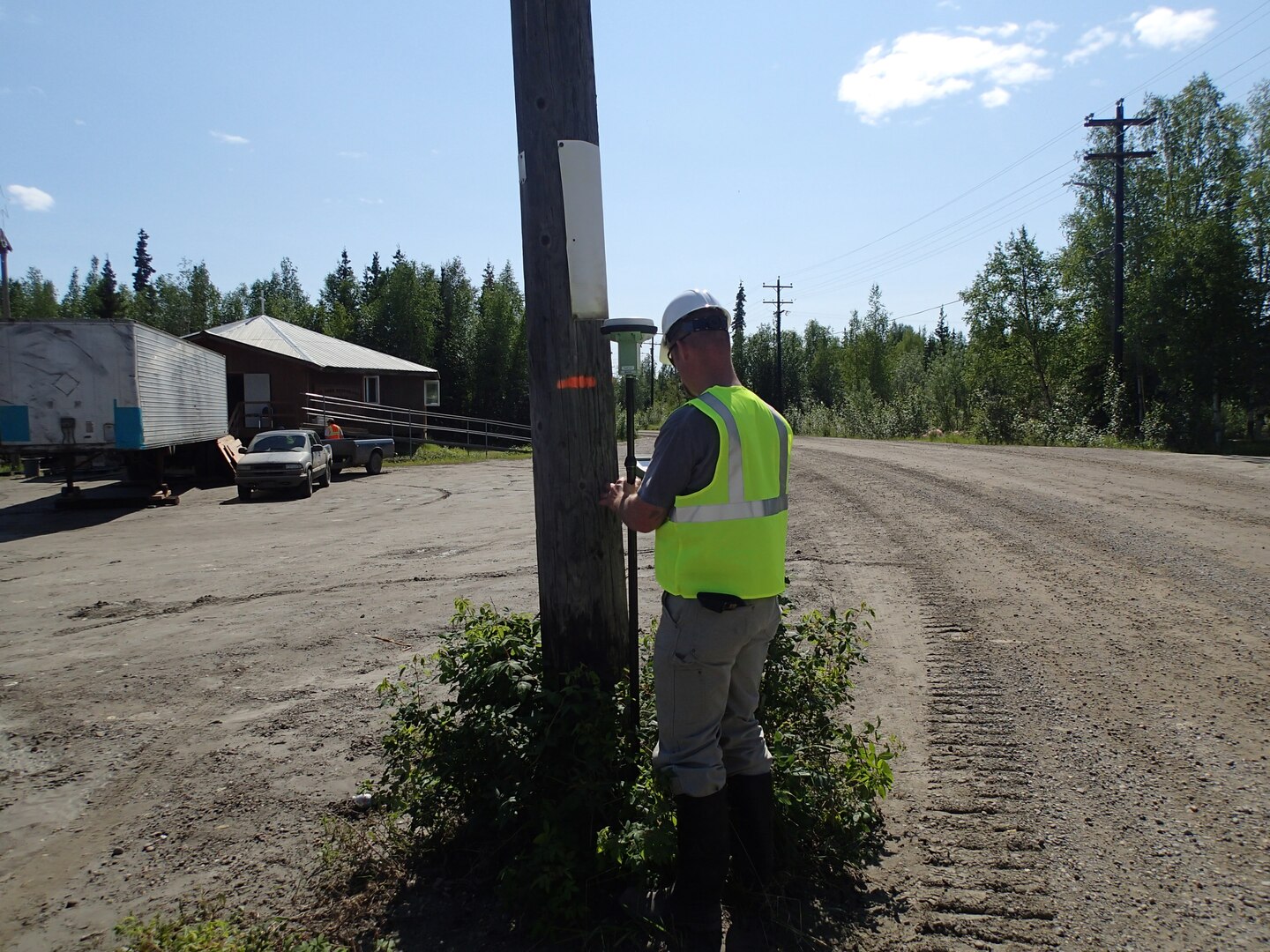Tatton Suter, plan formulator in the Alaska District Civil Works Branch, records high water marks that occurred May 29 using a GPS rover system. This phase of the project was coordinated through the Alaska District Floodplain Management Program at the request of the state. High water marks were used by the Corps for a baseline structure elevation study. 