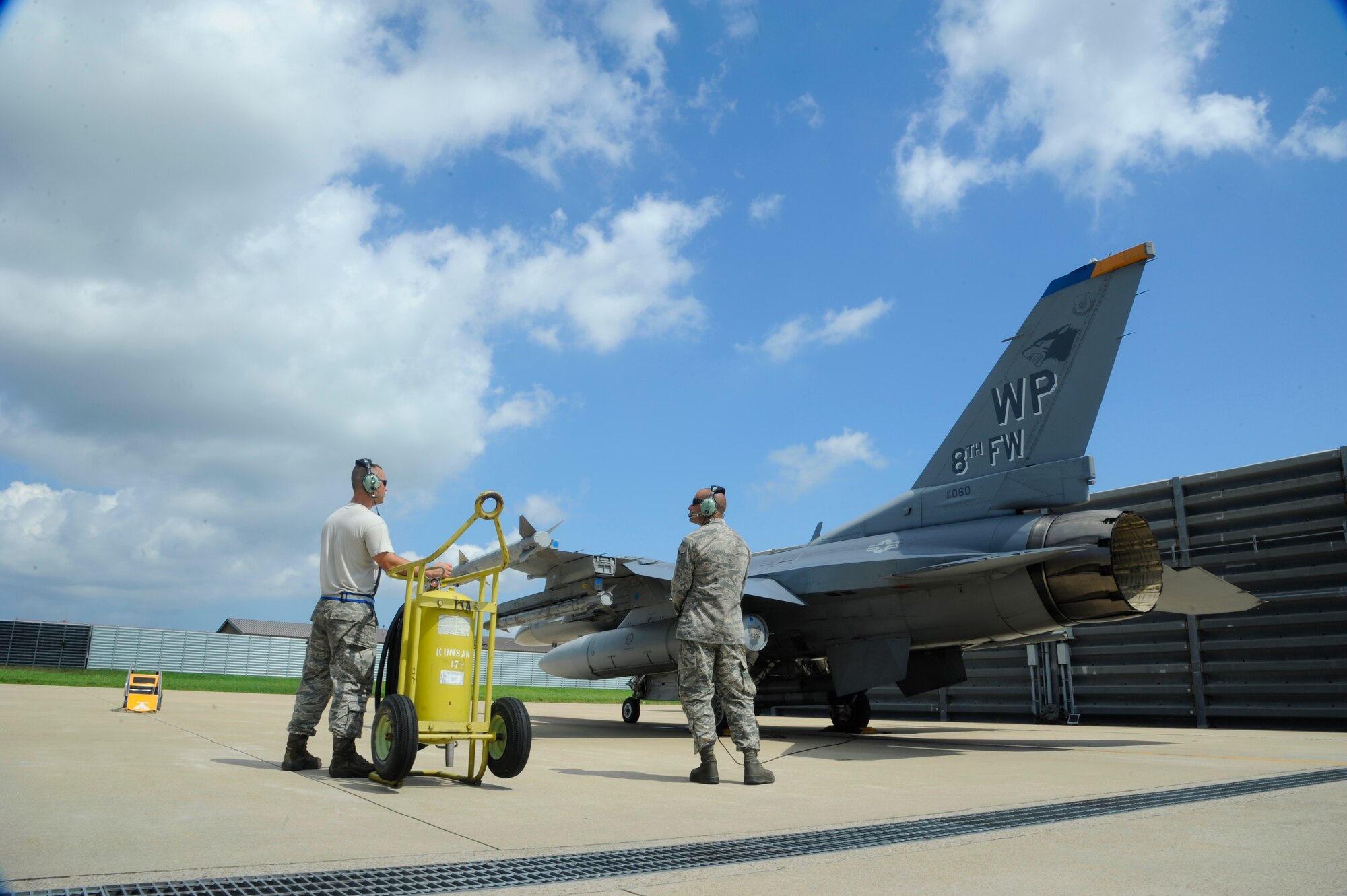 Senior Airman Stephen Mrozynski, 8th Aircraft Maintenance Squadron avionics specialist, and Senior Airman Alex Lenz, 8th AMXS crew chief, assist Col. S. Clinton Hinote, 8th Fighter Wing commander, with flight preparations at Kunsan Air Base, Republic of Korea, Aug. 14, 2013. Flight preparations were for a Kunsan Air Base tradition flight known as the ‘Friendship Flight’, which involves flying in unison over several landmarks around Gunsan, Republic of Korea. (U.S. Air Force photo by Staff Sgt. Jessica Haas/Released)