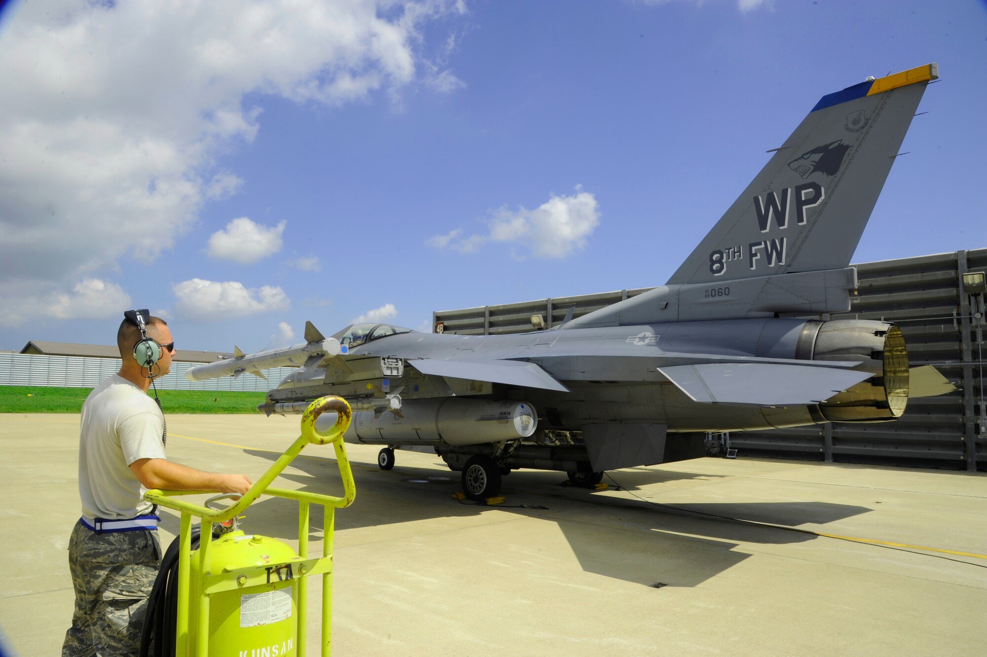 KUNSAN AIR BASE, Republic of Korea – Senior Airman Stephen Mrozynski, 8th Aircraft Maintenance Squadron avionics specialist, assists Col. S. Clinton Hinote, 8th Fighter Wing commander, with flight preparations, Aug. 14, 2013. The flight preparations were for a time-honored tradition known as the ‘Friendship Flight’, which includes leadership from the 8th FW and 38th Fighter Group, and gives the U.S. and ROK pilots an opportunity to work and train together. (U.S. Air Force photo by Staff Sgt. Jessica Haas/Released)
