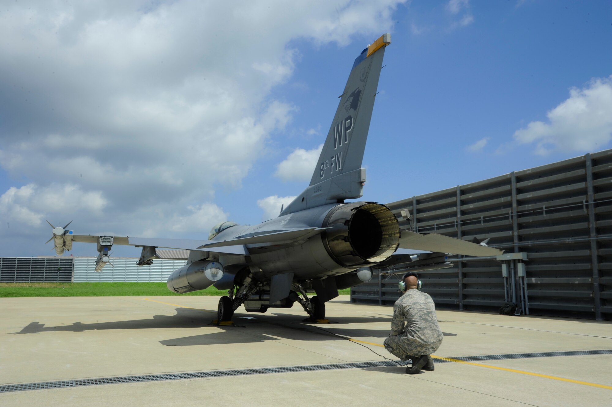 KUNSAN AIR BASE, Republic of Korea – Senior Airman Alex Lenz, 8th Aircraft Maintenance Squadron crew chief, assists Col. S. Clinton Hinote, 8th Fighter Wing commander, with flight preparations, Aug. 14, 2013. The colonel was preparing for a flight with the leadership of the 38th Fighter Group, a Republic of Korea air force group stationed here. (U.S. Air Force photo by Staff Sgt. Jessica Haas/Released)
