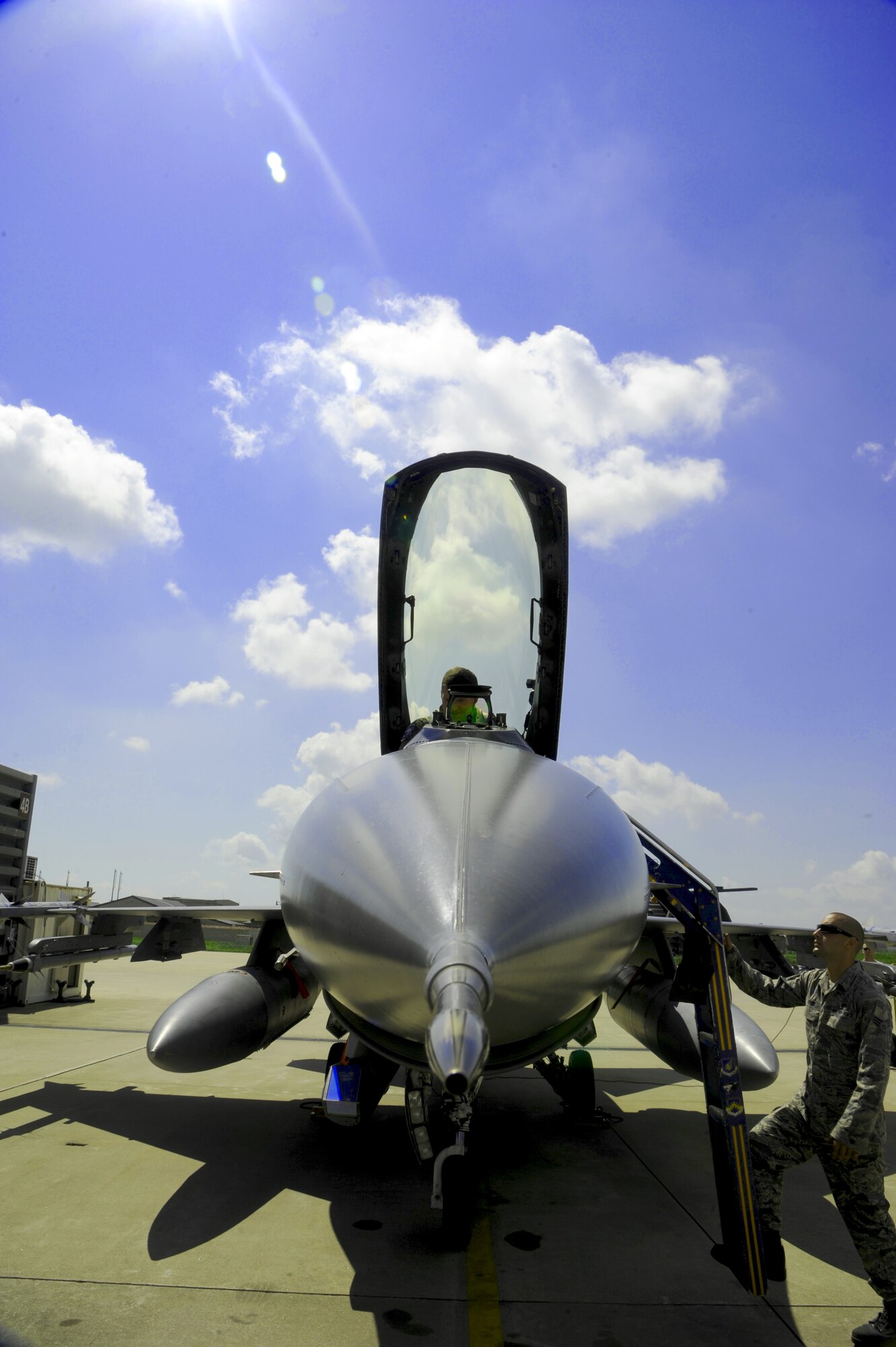 KUNSAN AIR BASE, Republic of Korea – Colonel S. Clinton Hinote, 8th Fighter Wing commander, prepares for a ‘Friendship Flight’ with the help of his crew chief, Senior Airman Alex Lenz, 8th Aircraft Maintenance Squadron, Aug. 14, 2013. The commander flew alongside Republic of Korea air force Col. Min-Oh Seo, 38th Fighter Group commander, as part of a tradition symbolizing the longstanding cooperation between the U.S. and the ROK. (U.S. Air Force photo by Staff Sgt. Jessica Haas/Released)