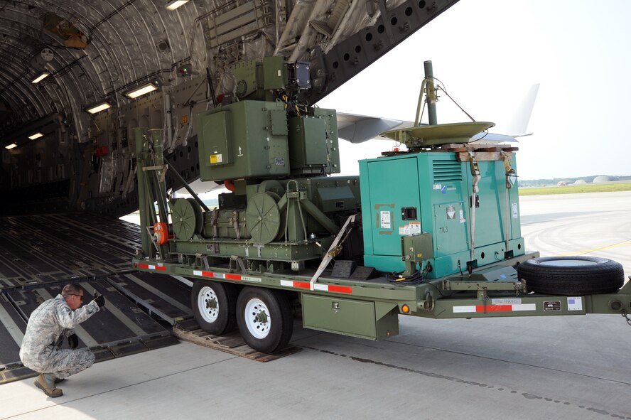 A Joint Deployable Electronic Warfare Range is unloaded from a C-17 Globemaster III at Misawa Air Base, Japan, Aug. 11, 2013. The JDEWR is a warfare system that provides tactical-level training to participants in live training events. It’s implemented as a threat capable of submitting ground threat defenses for F-16 Fighting Falcon pilots at Misawa AB. (U.S. Air Force photo/Senior Airman Derek VanHorn)