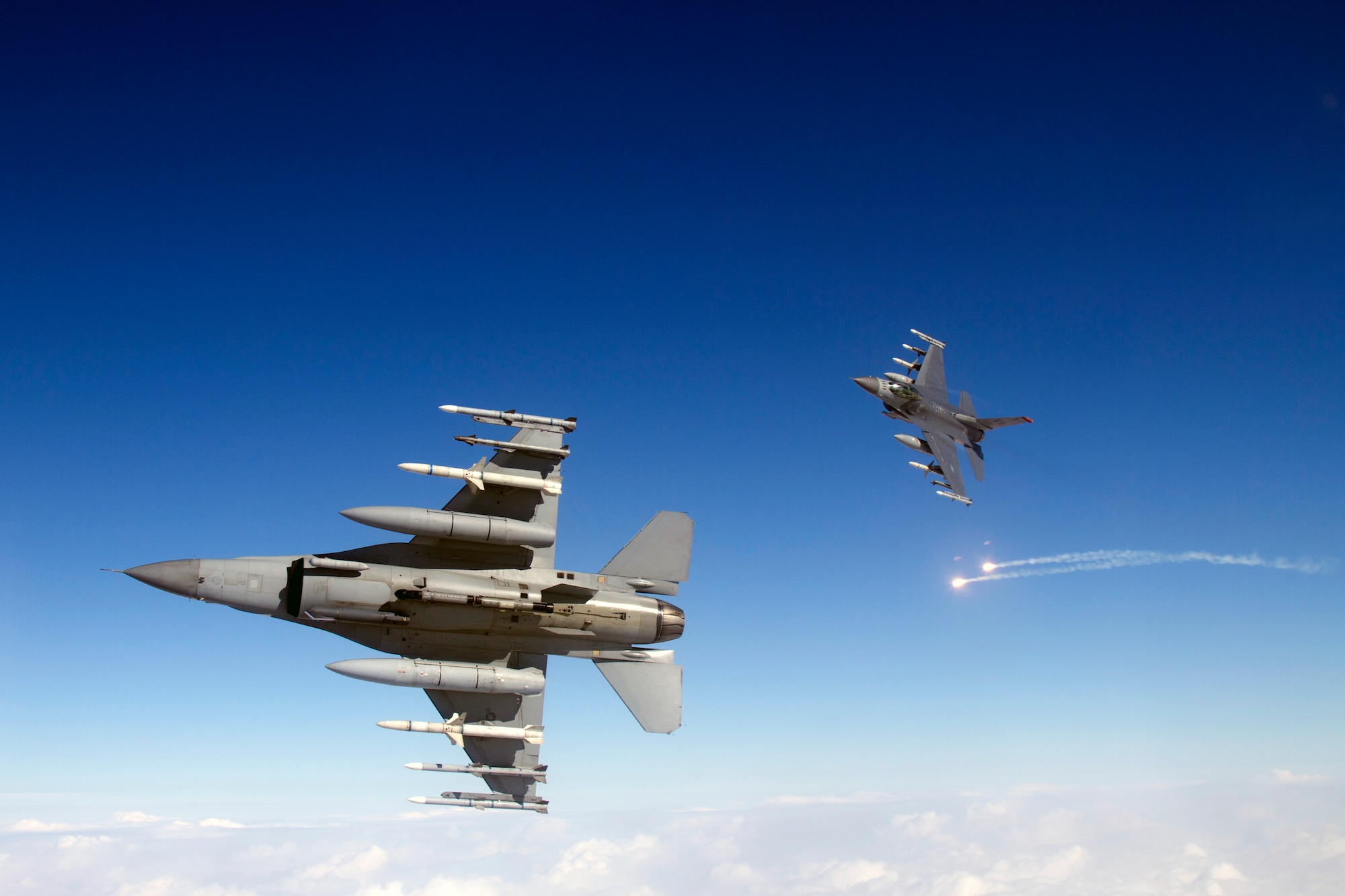 Two U.S. Air Force F-16 Fighting Falcons from the 35th Fighter Wing conduct Suppression of Enemy Air Defense training over Misawa Air Base, Japan, Feb. 14, 2013. Pilots at Misawa received a Joint Deployable Electronic Warfare Range to be placed at Draughon Range, an area located only 10 nautical miles north of the base where pilots are authorized to drop live ordnance during training. (Courtesy photo/Jake Melampy)