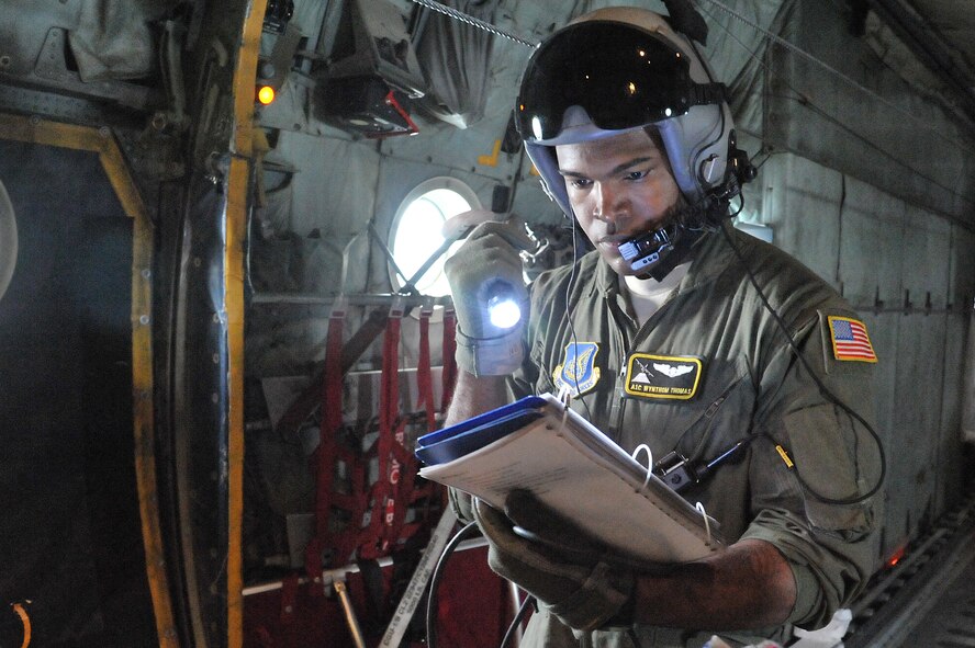 Airman 1st Class Wynthom Thomas, 36th Airlift Squadron loadmaster, looks over a checklist during joint jump training at Yokota Air Base, Japan, Aug. 21, 2013.  The training provided an opportunity for both Airmen and Soldiers to improve their interoperability.  (U.S. Air Force photo by Airman 1st Class Soo C. Kim)